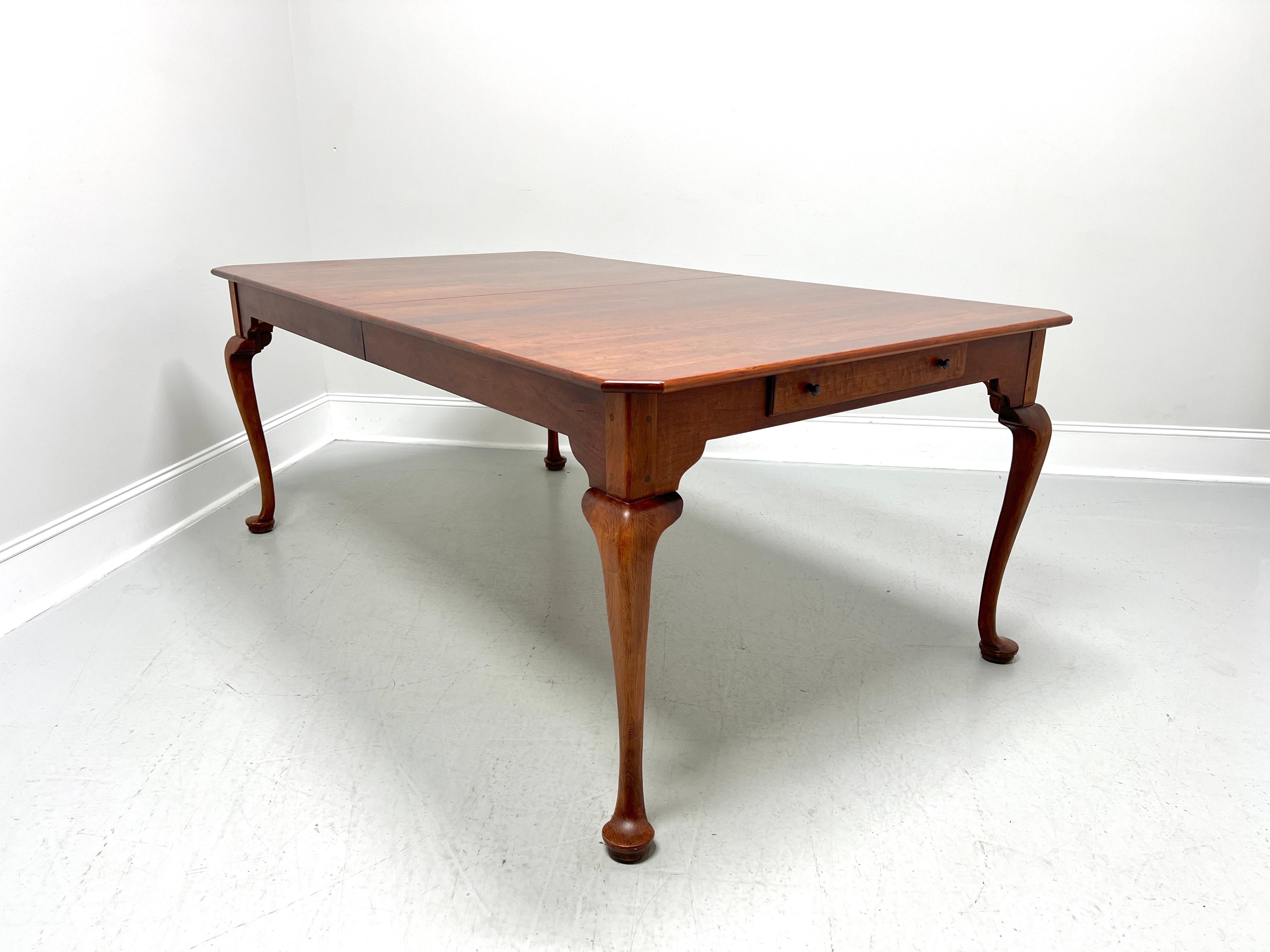 A Queen Anne Farmhouse style rectangular dining table by Lexington Furniture, from their Bob Timberlake Collection. Solid cherry wood, rounded edge with clipped corners to the top, smooth apron carved at legs, one felt lined drawer of dovetail