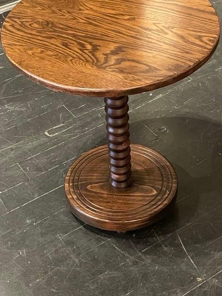 1940's French bobbin leg side table in the style of Charles Dudouyt.
The top and base are round.
Three decorative rings on the base.
Beautiful patina showing the wood grain prominently.