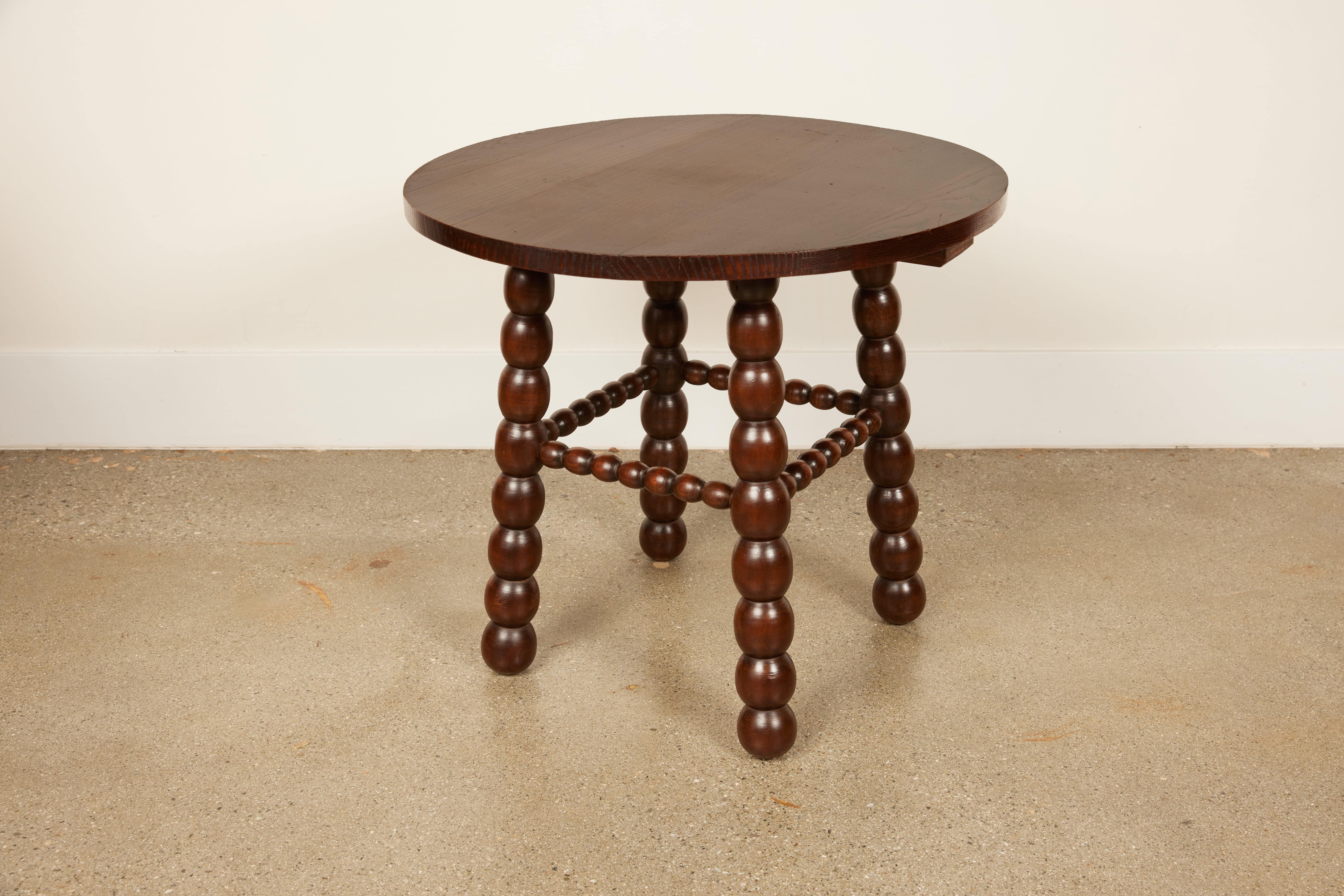 Discover the elegance of mid-century French design with our authentic 1940s Bobbin Table. Crafted from rich mahogany and preserved in its original condition, this piece features a 23