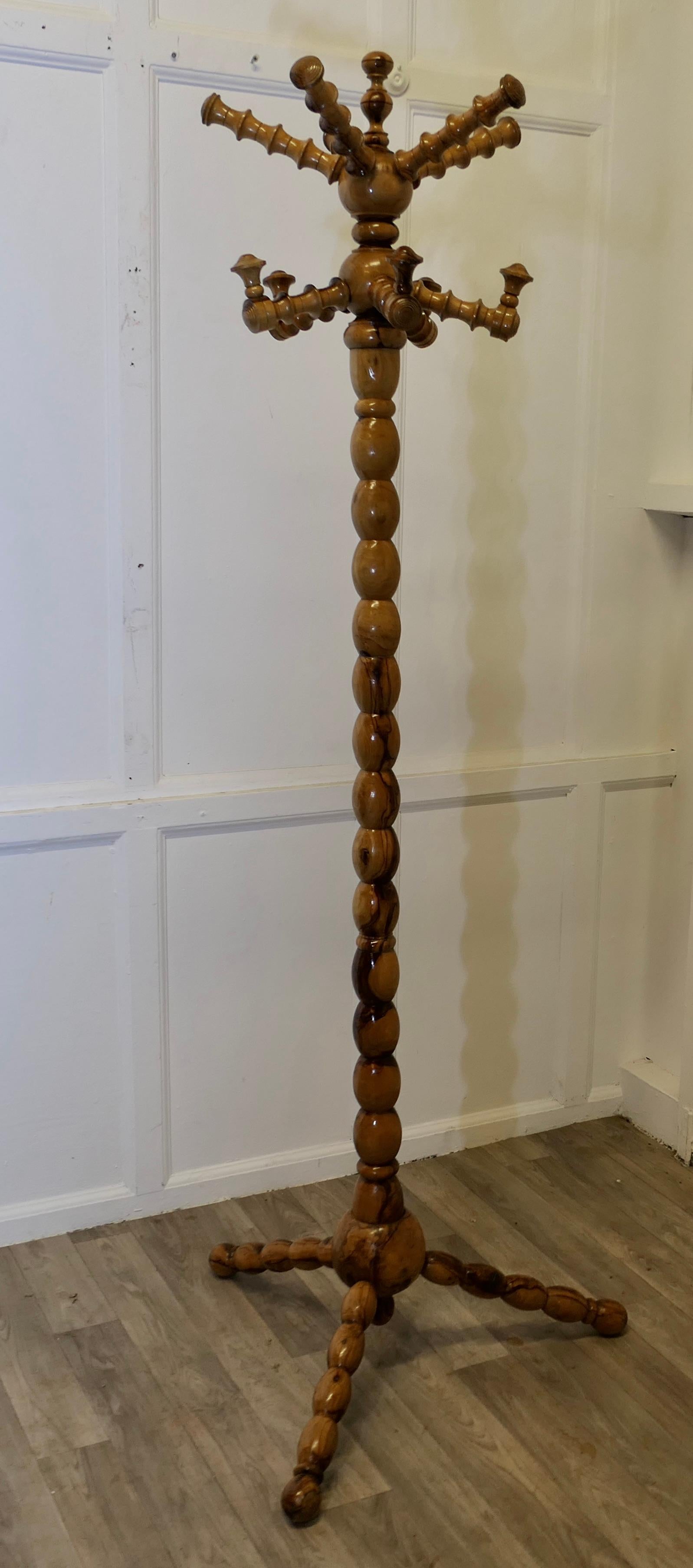 Bobbin Turned Yew Wood Hall Stand for Hats Coats and Umbrellas 

This is an Unusual Hat & Coat Hall Stand it has 5 Large Hat pegs at the top, 5 more for coats below, the stand sits firmly on a 4 footed base, it is heavy and sturdy, the wood used