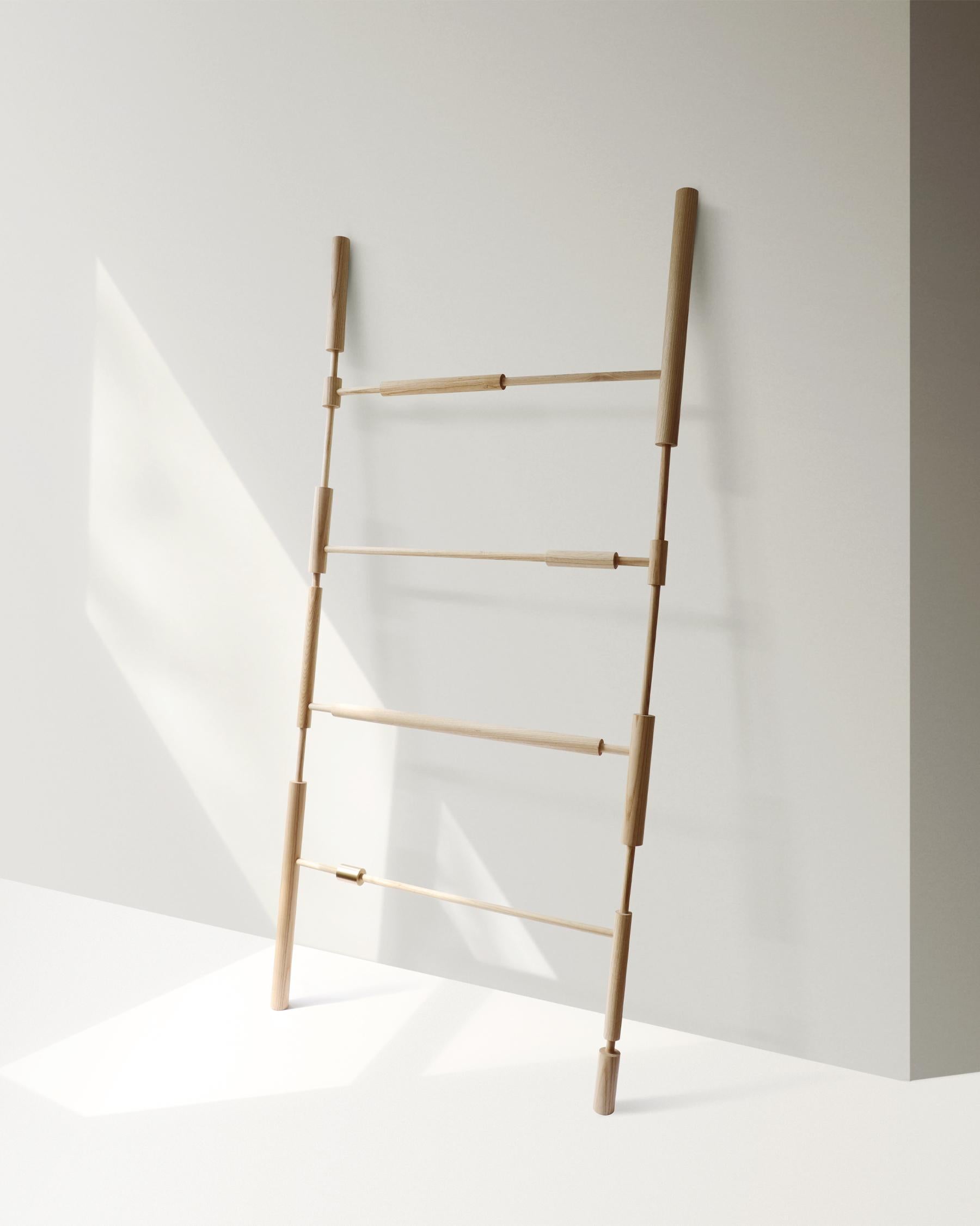 Bobines ash wood display unit by Homefolks
Dimensions: D 5.9 x W 87.5 x H 190cm 
Materials: ash wood, brass

The Bobines display unit is handmade from natural ash and solid brass. Its sculptural, fragmented line composes a playful set up to