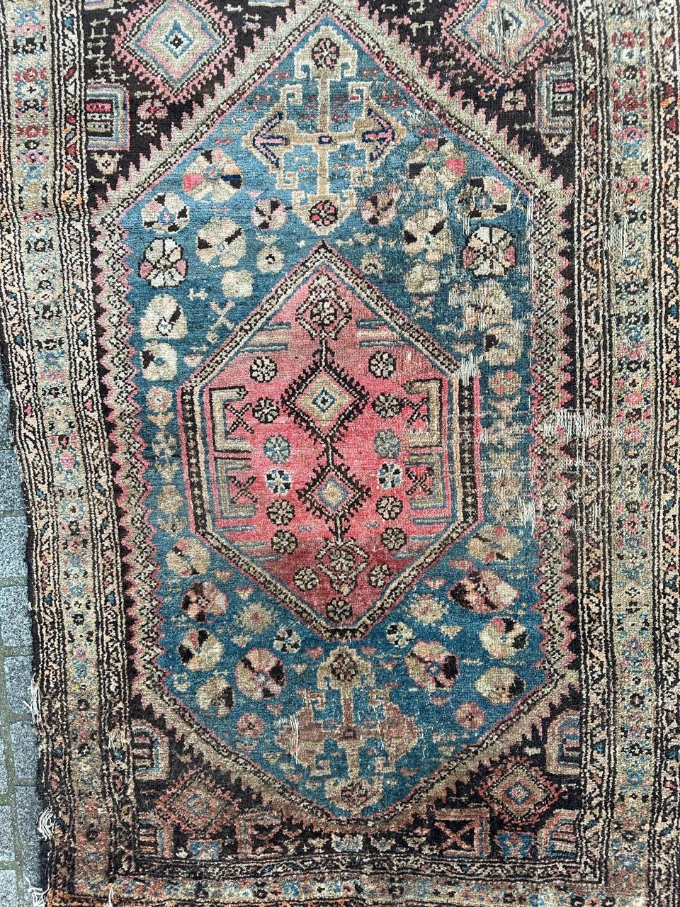Early 20th century distressed Kurdish rug with beautiful geometrical and tribal design and nice natural colours with sky blue, pink, brown and green, entirely hand knotted with wool on cotton foundation.
Many damages and wears , distressed
