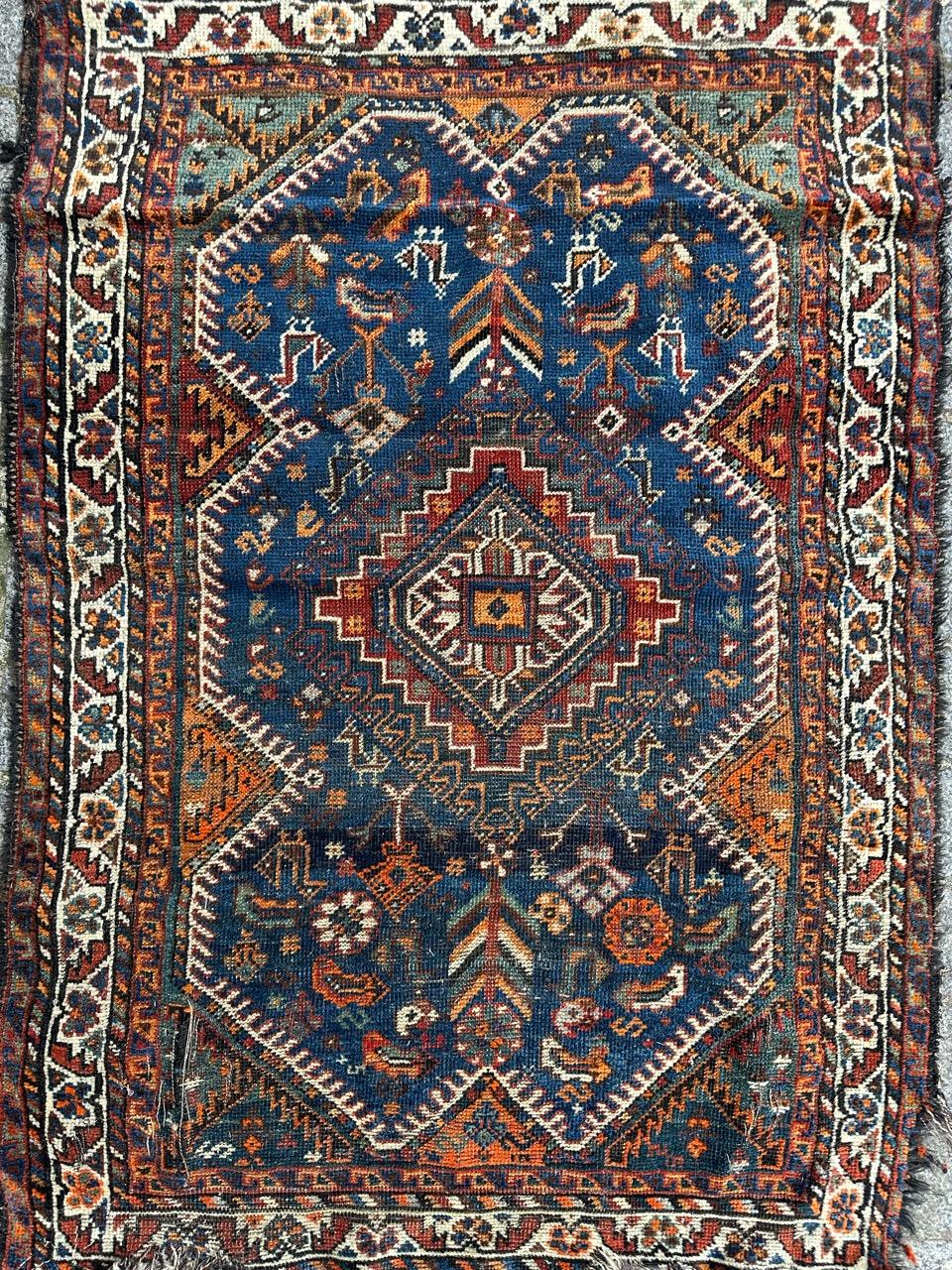 Beautiful early 20th century distressed Shiraz rug with nice geometrical and tribal design with nice natural colours with blue, green, orange, purple and brown, entirely hand knotted with wool on wool foundation 
Damaged and wears, losses at the