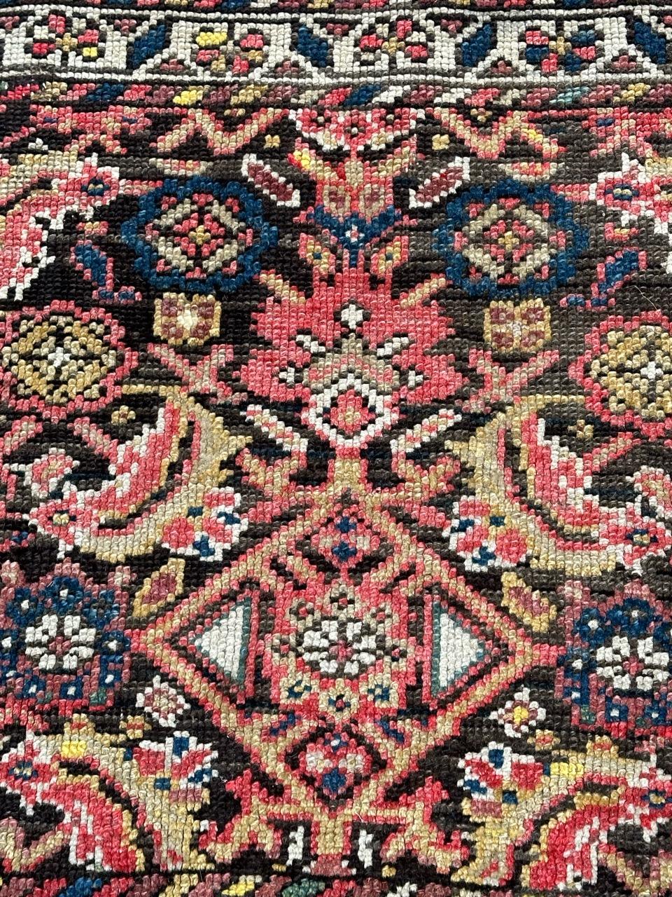Pretty small malayer bag face rug with nice tribal and Herati design, and beautiful natural colours with red, green, blue and white on a brown backdrop and with a white field border adorned by stylized flowers in purple, blue, red and yellow.