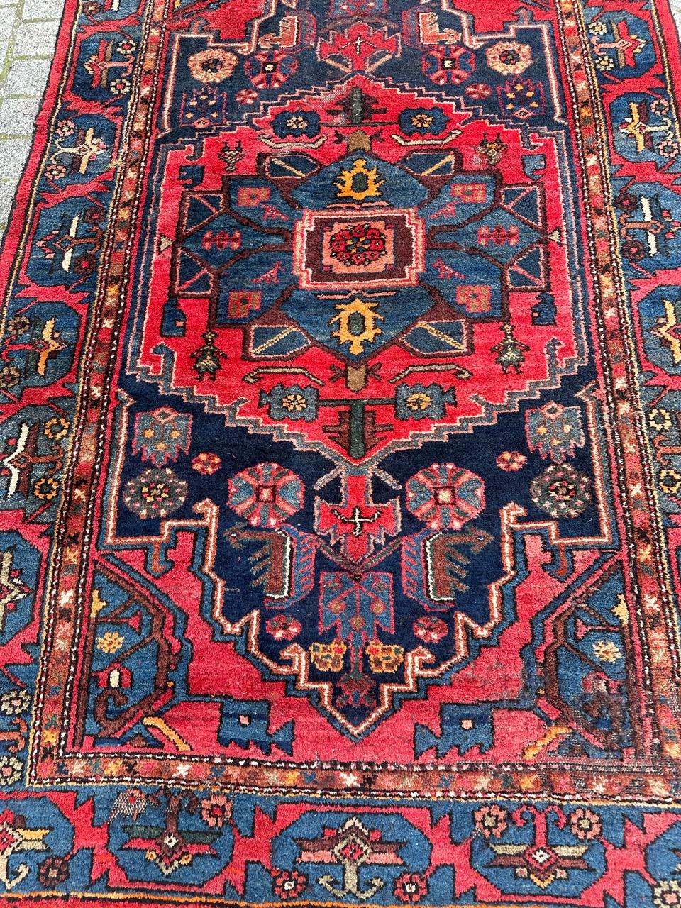 Pretty mid century rustic Hamadan rug with beautiful geometrical and tribal design and nice colours with a red and blue navy field colours, also yellow, pink, brown and orange in design, entirely hand knotted with wool on cotton foundation. Wears on