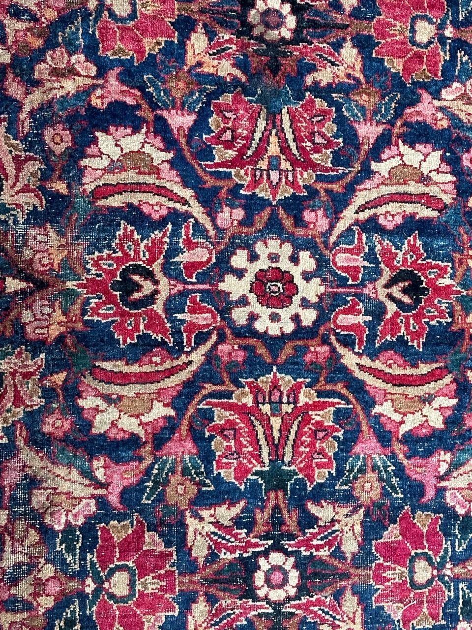 Beautiful late 19th century Yazd rug with nice floral design with stylized flowers, leaves and branches, and beautiful natural colours with a dark blue field and pink, red, yellow and brown, entirely hand knotted with wool on cotton