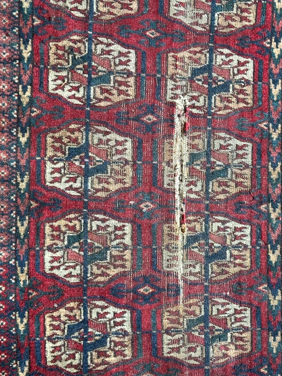 Beautiful antique Turkmen Bokhara distressed rug with nice geometrical and tribal design of Bokhara rugs, and nice natural colours with red, blue, orange, yellow and white, entirely and finely hand knotted with wool on wool foundation