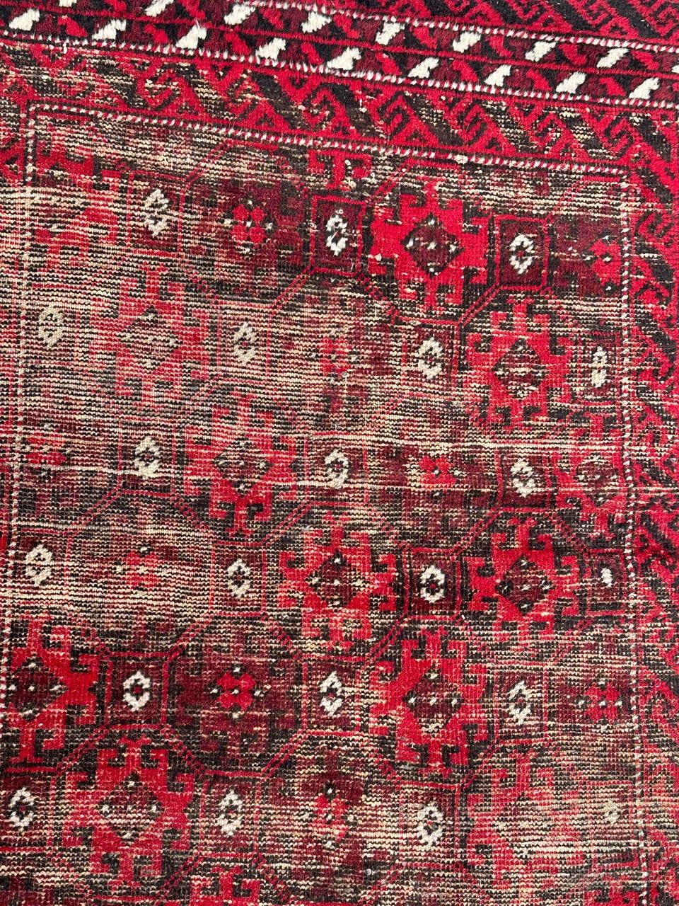 Pretty vintage distressed rug, Baluch , with a tribal and stylized designs, and beautiful colours with red, purple, black and white, uniformly used due to the age and the use, entirely hand knotted with wool on the cotton