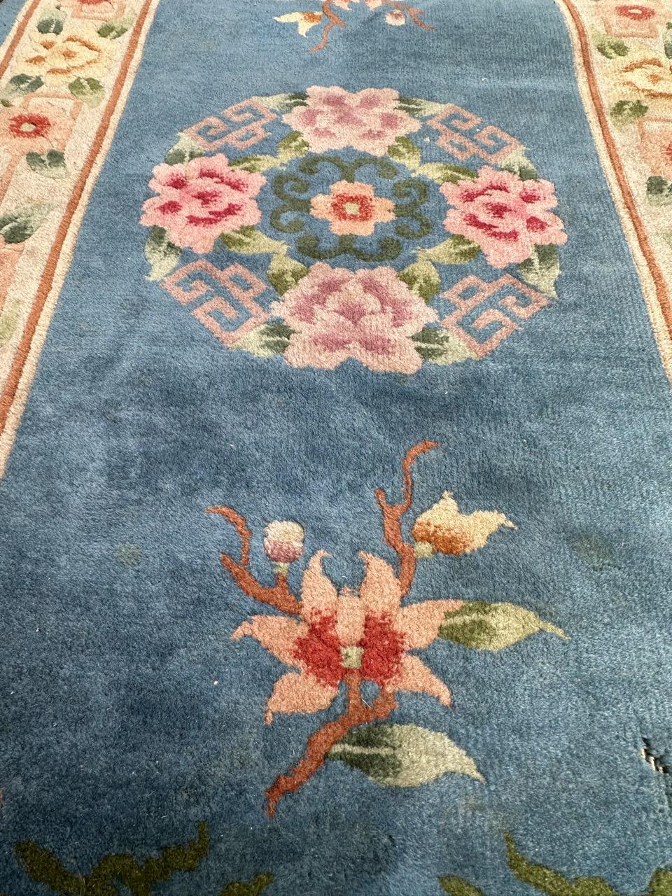 Pretty 20th century Chinese rug with beautiful Chinese floral design and nice colours with a sky blue field and pink, orange, brown, purple, green and white in design and borders. Entirely hand knotted with wool on cotton foundation. Little wear of