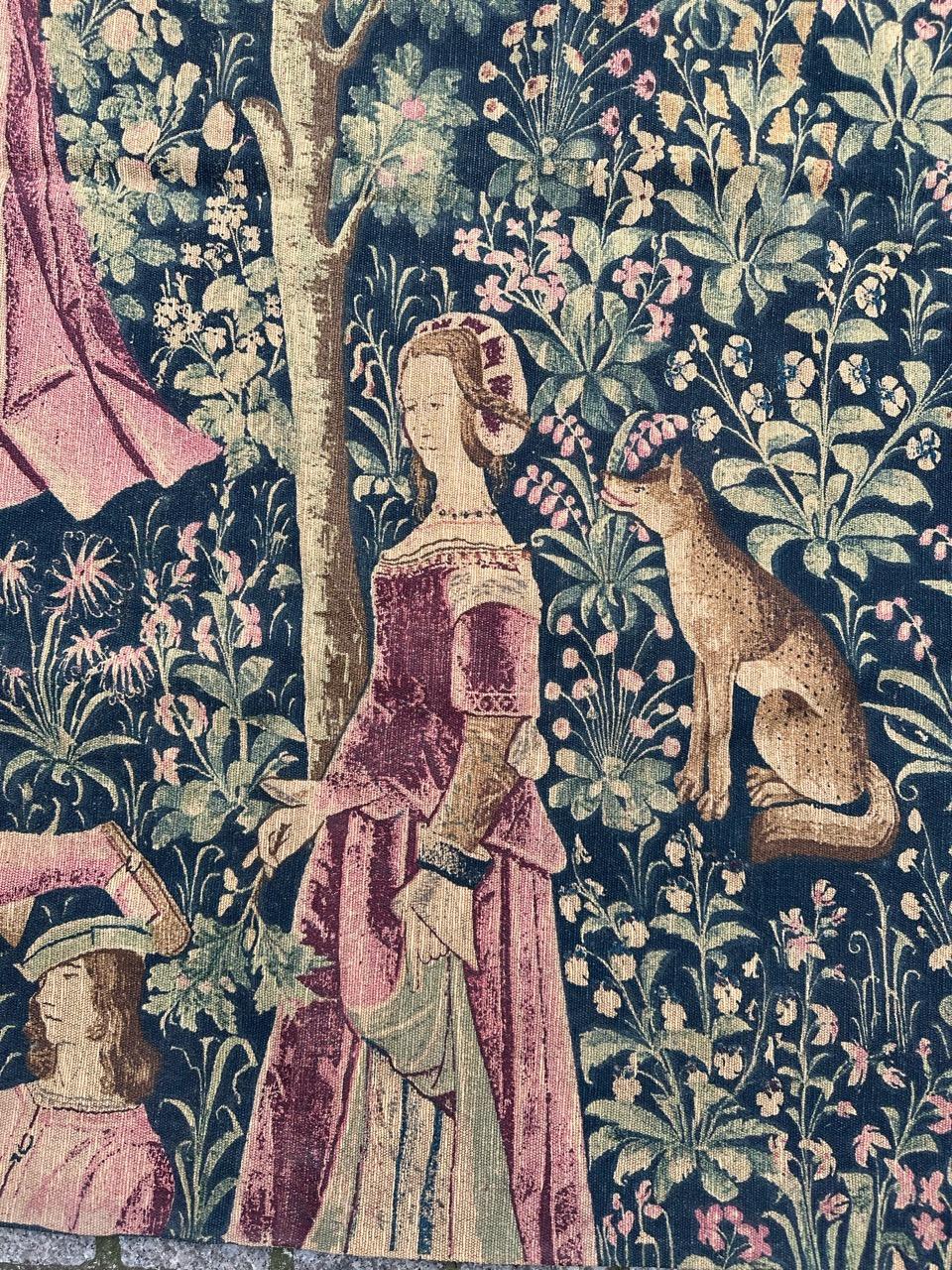 Nice vintage French hand printed tapestry with beautiful medieval design and beautiful colors. Discover a stunning mid-20th-century tapestry, meticulously hand-printed on a cotton foundation. This exquisite tapestry features the scene: 