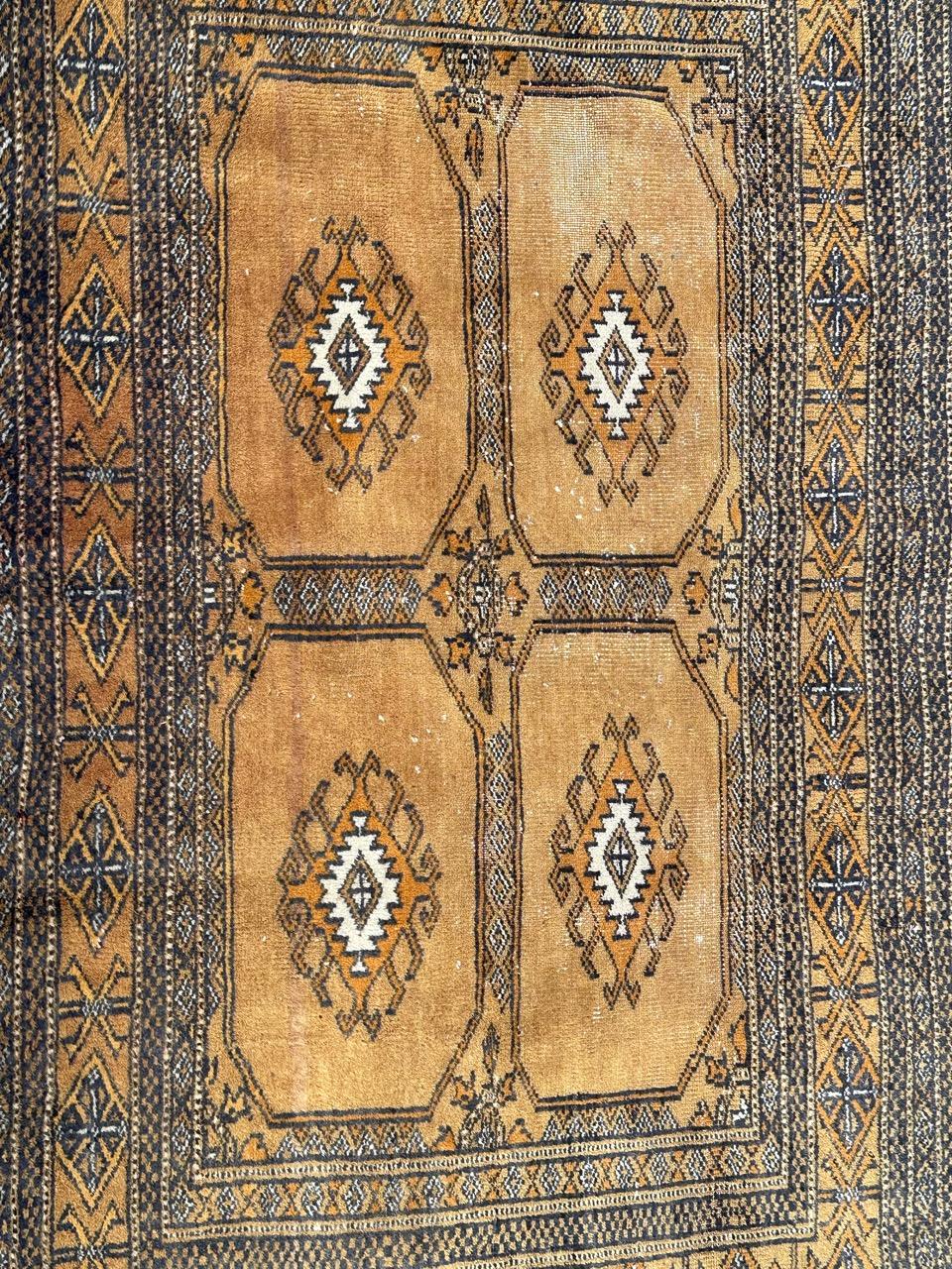 Beautiful vintage Pakistani Turkmen chuval style rug with beautiful Bokhara design and nice colours with red orange, yellow, pink , black and white, entirely and finely hand knotted with wool on cotton foundation. 
Small wears due to age and use