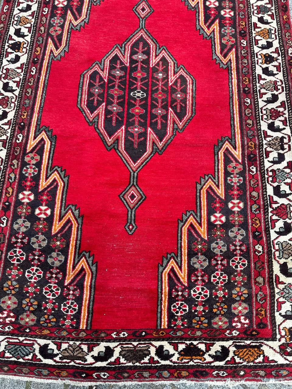 Beautiful mid century tribal mazlaghan rug with beautiful geometrical and typically of mazlaghan rugs, and nice colours with a vibrant red field and dark brown, red, green, orange, pink, grey and white in design. Entirely hand knotted with wool on