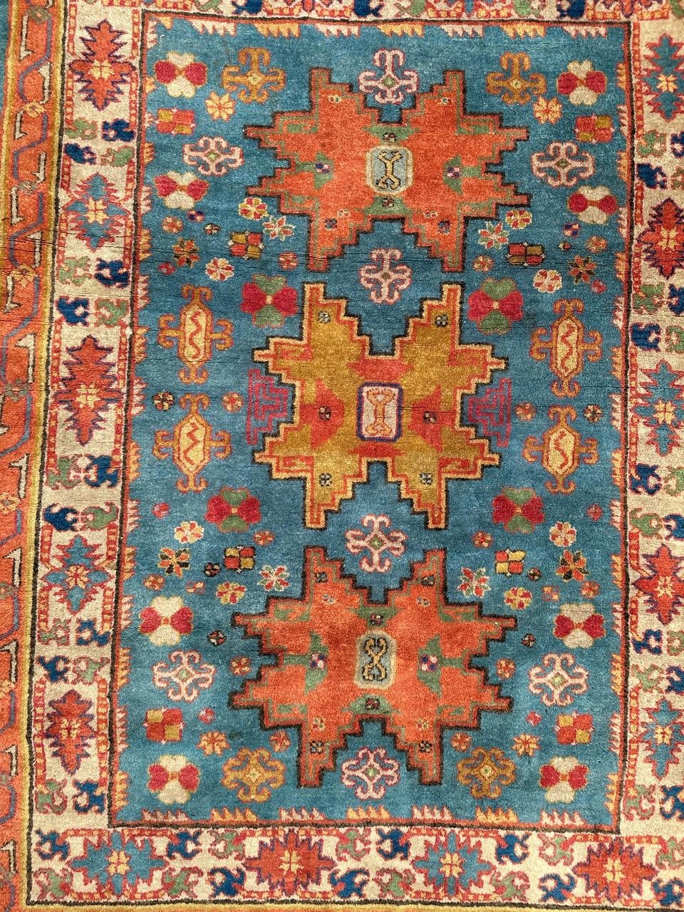 Very beautiful mid century Chinese Xinjiang rug with nice geometrical design of Caucasian shirvan Lesgui rugs, with stylized designs and nice colours with a sky blue field and blue, green, pink, yellow and orange in design. Entirely hand knotted