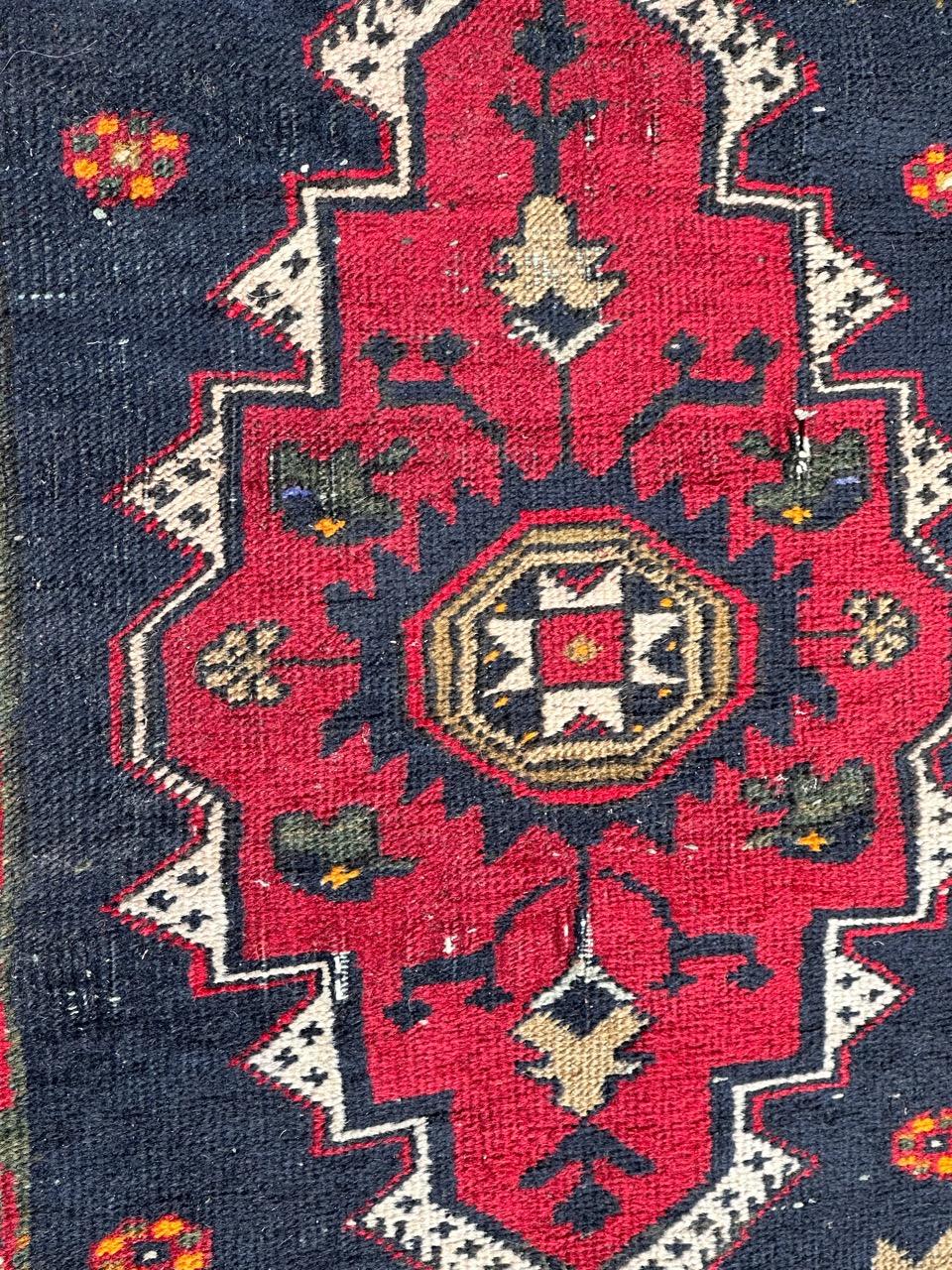 Pretty mid century Turkish Yastik rug with beautiful geometrical design and nice colours with a red, dark blue , orange , green, black and white , entirely hand knotted with wool on cotton foundation. Some wears due to the age and the