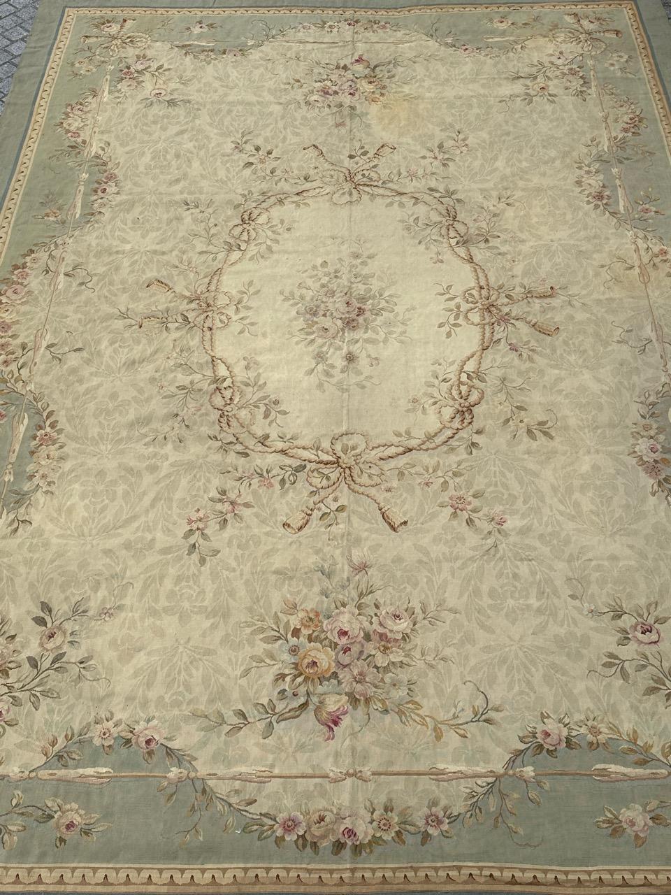 Exquisite large Antique French Aubusson rug from the early 20th century, meticulously handwoven in wool on Aubusson looms. Featuring a Louis XVI-style floral design in lovely light hues, the beige backdrop adorned with delicate light green leaves