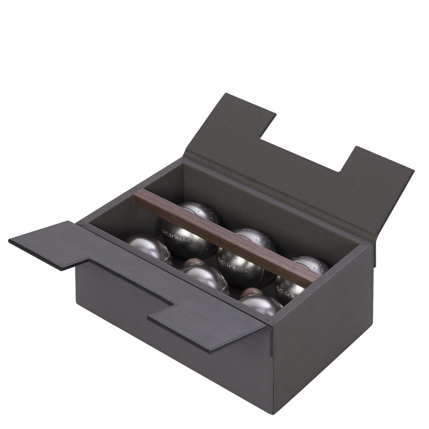 Composed of six heavy stainless steel balls and two wooden jacks that serve as target balls, this exquisite bocce set comes in an elegant and original gray leather-covered wood box embellished with a solid walnut wood handle. This popular