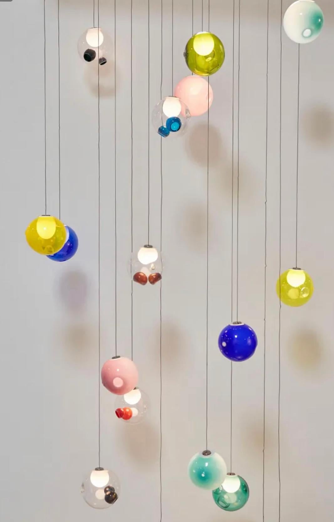 28.20 is a low-voltage arrangement of 20 blown-glass spheres. Each sphere contains an interior landscape of satellite shapes, including an opaque milk glass diffuser that houses the light source. 28.20 uses headphone jack connections, which allow