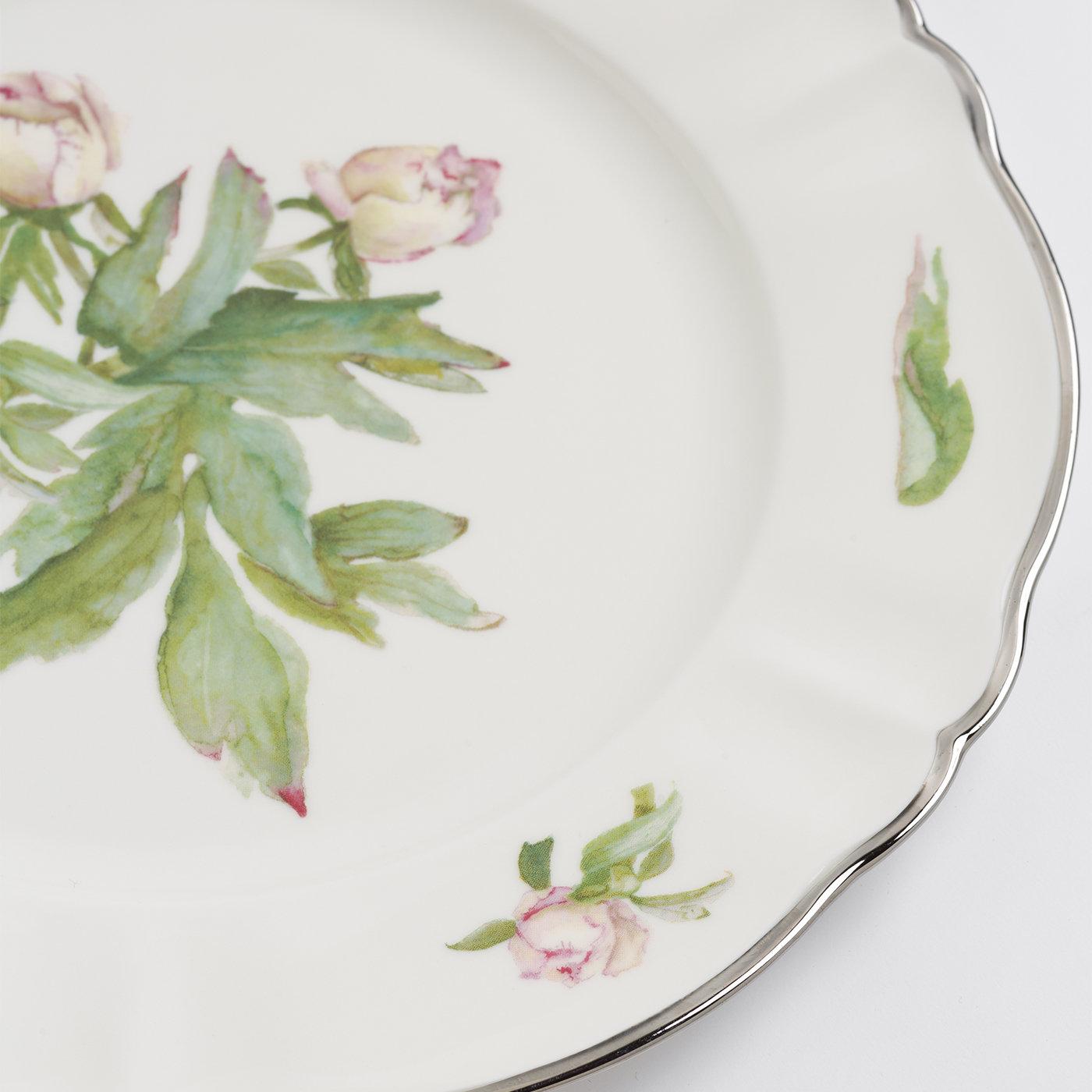This romantic tray of fine ivory porcelain reveals a first-rate artisan quality flaunted through its classic design and hand-painted, floral decorations - gracing both the center and the edge - rendered in vivid details. Inspired by a drawing of