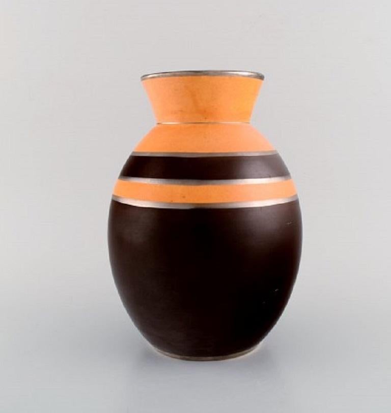 Boch Freres Keramis, Belgium. Rare Art Deco vase in glazed ceramics. 
Brown and orange glaze with silver decoration. 1930s.
Measures: 24.5 x 17.5 cm.
In excellent condition.
Stamped.
Model number: D1818.