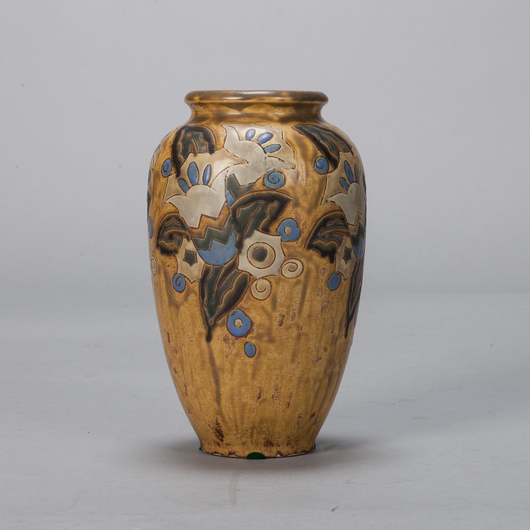 Art Deco era Boche ceramic vase with mustard/gold colored glazed with blue stylized floral design attributed to Charles Catteau. Marked on the bottom Gres Keramis - Boche Belgium 911.