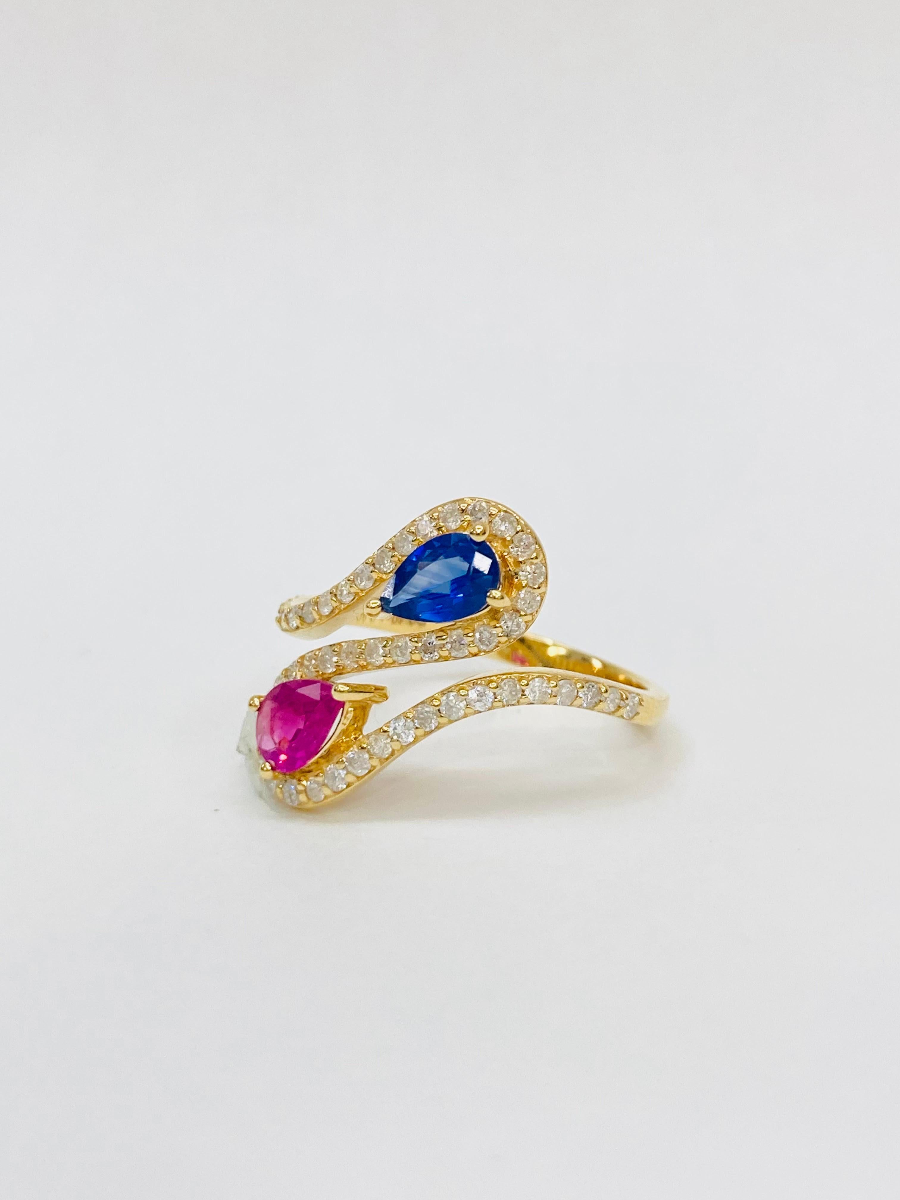 Bochic 2 Color “Retro Vintage” Ruby & Sapphire 18K Gold & Diamond Cluster Ring.

Natural Red Ruby Pear Shape 0.40 Carat 
Natural Blue Sapphire Shape  0.40 Carat 
Diamonds 0.45 Carat 
F color 
VS clarity 
18K Yellow Gold
5.10 Gram

This Ring is from