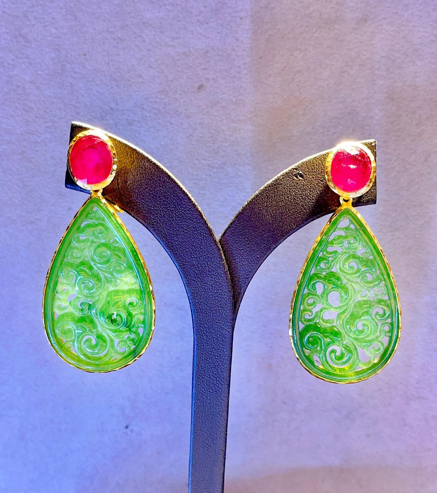 Beautiful Green Jade, Blue Sapphire & Red Ruby Earrings
Multi Natural Gem Earrings 
Set in 22K Gold and Silver 
Natural Ruby, Colors - Red, Pink, 7 Carats 
Ethiopian White Opal and Australian Blue Opal, 7 Carats 
This earrings are the perfect cross