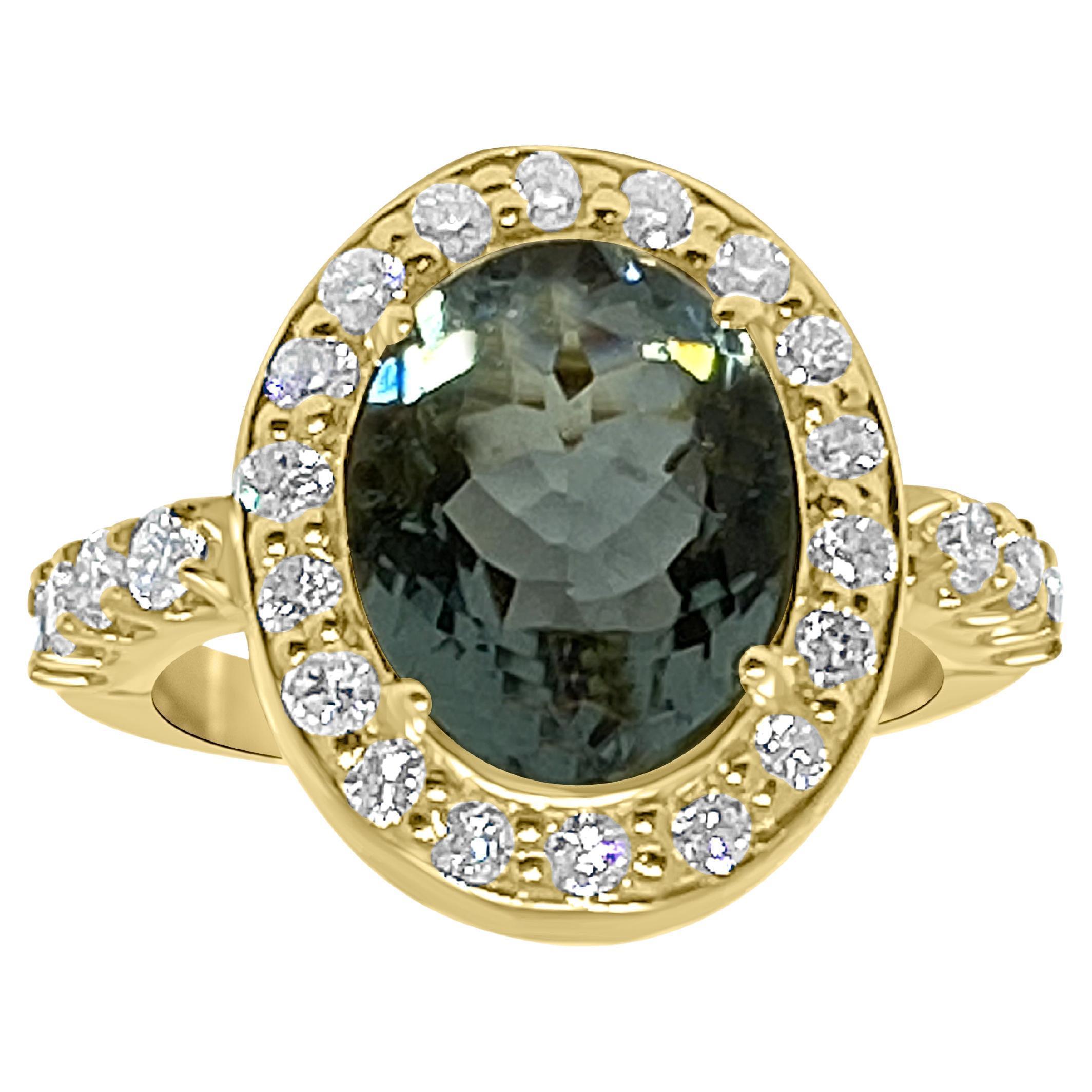 Bochic Oval shape Tiel/Blue Tourmaline and Diamond Cocktail Ring.
Center Oval shape Tourmaline 5.04 Carat
White Diamond cluster and side diamonds 0.87 Carat 
18 K Yellow gold 
29 Grams 
Elegant, Timeless and Chic 
Signed Bochic 
Bochic black lather