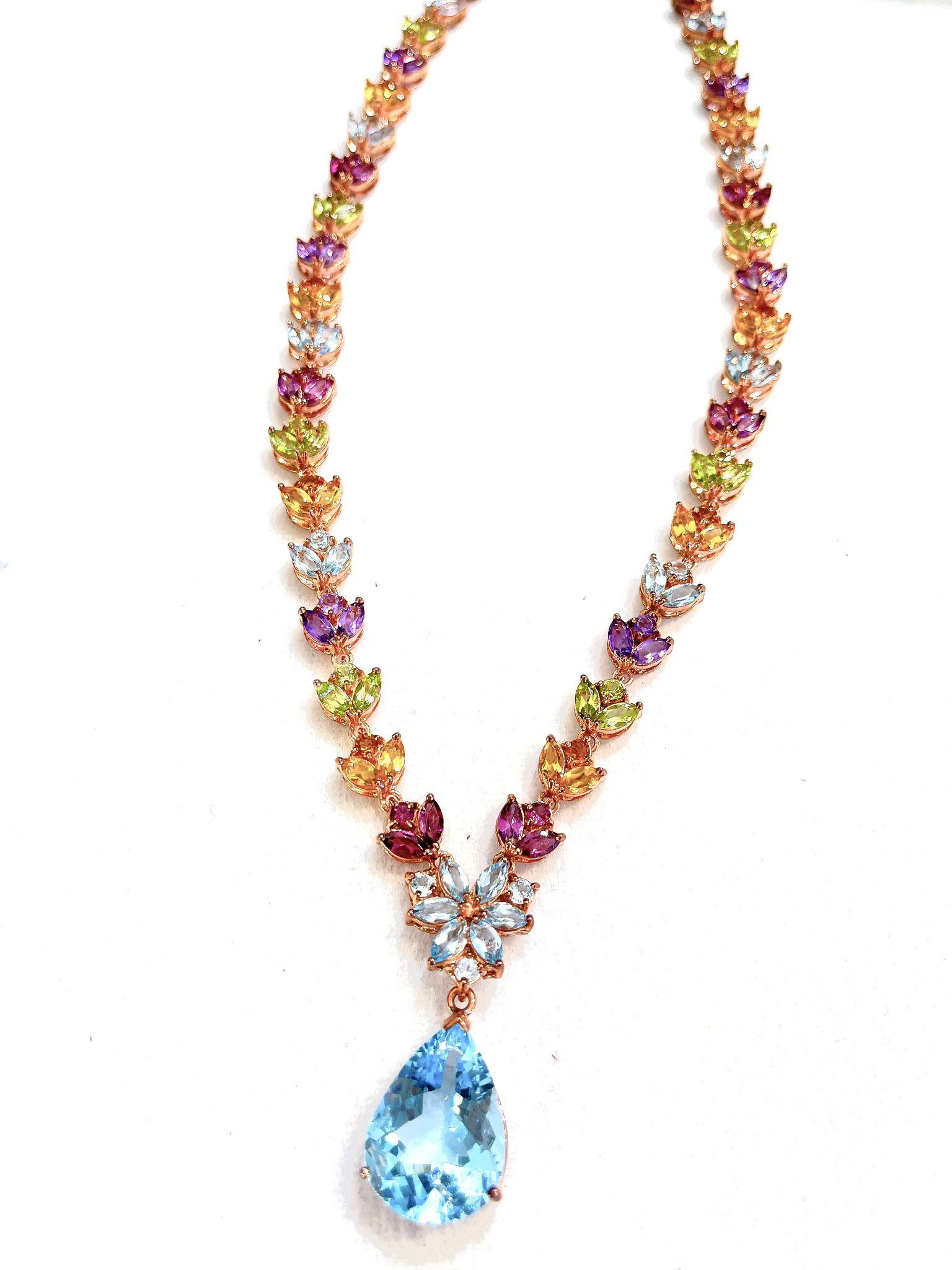 Bochic “Capri” Amethyst, Topaz, Citrine & Peridot Necklace in 18K & Silver 

Green Peridot  - 5 Carats 
Blue Topaz pear shape drop - 7 Carats 
Citrine - 4 Carats 
Purple Amethyst - 4 Carats 
Rodholite - 4 Carats

The Bochic 