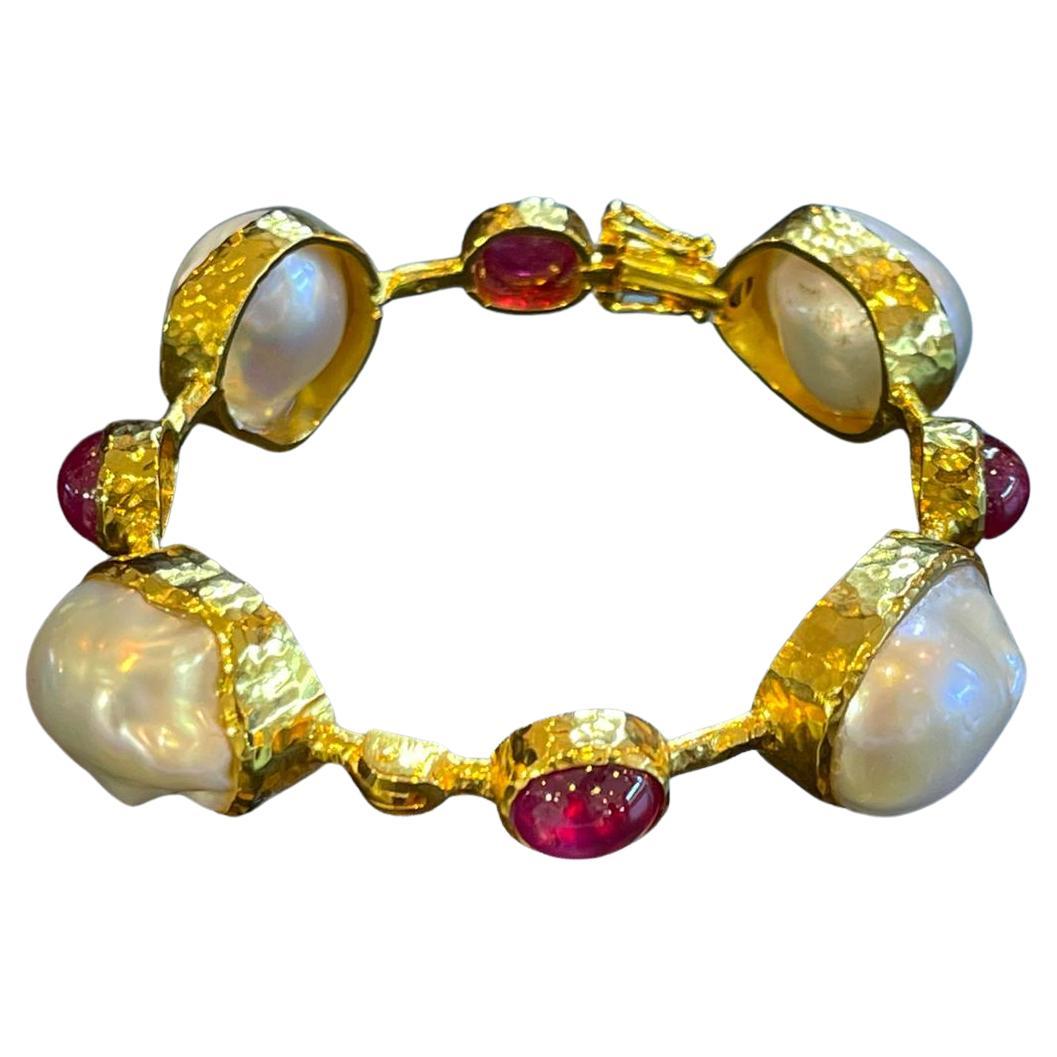 Bochic “Capri” Bangle, Ruby & South Sea Pearls set in 22 Gold & Silver 
Natural Red Ruby Cabochons - 9 carats in total, all around the bangle 
Shape - Oval shape Cabochon
Baroque white south sea natural cultured pearls all around the bangle 
White