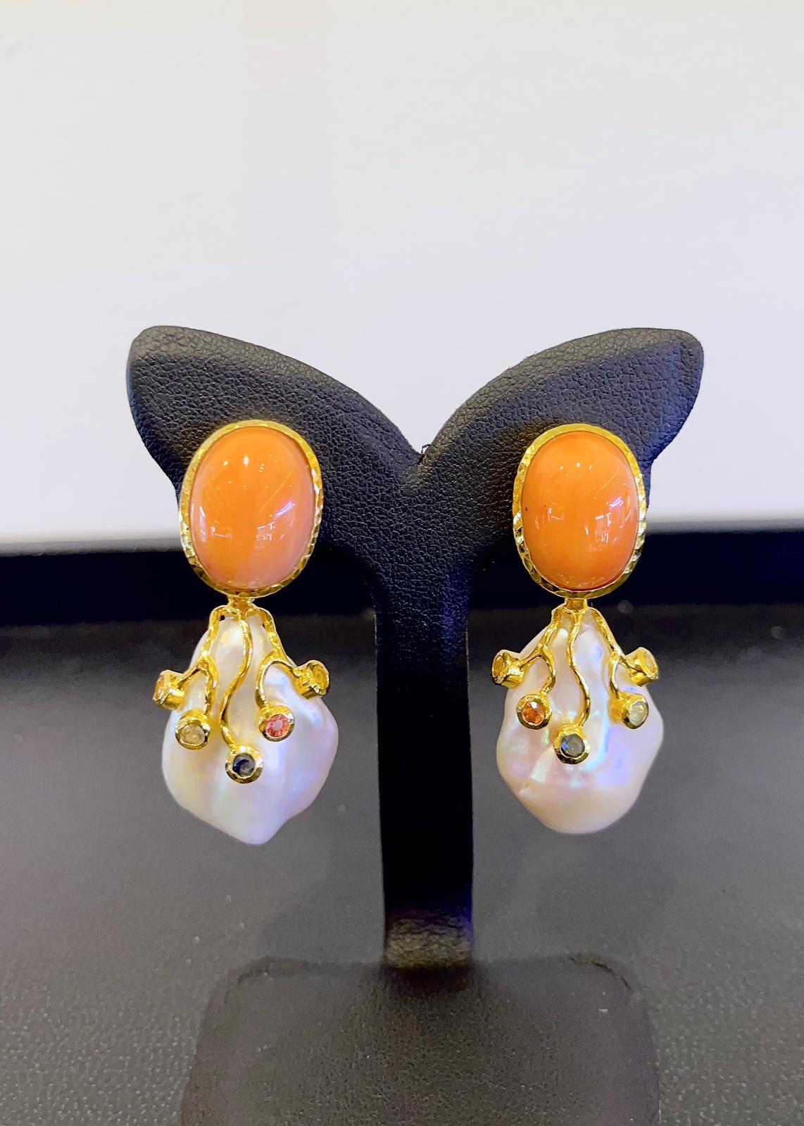 Bochic “Capri” Coral and Fancy Color Sapphire Earrings 
Drop earrings 
The coral is presses salmon coral 
Fancy color Natural, Blue, Pink, Yellow and Red Sapphires 
1.00 Carat 
Set in 22K Gold and Silver 
This earrings are the perfect cross between
