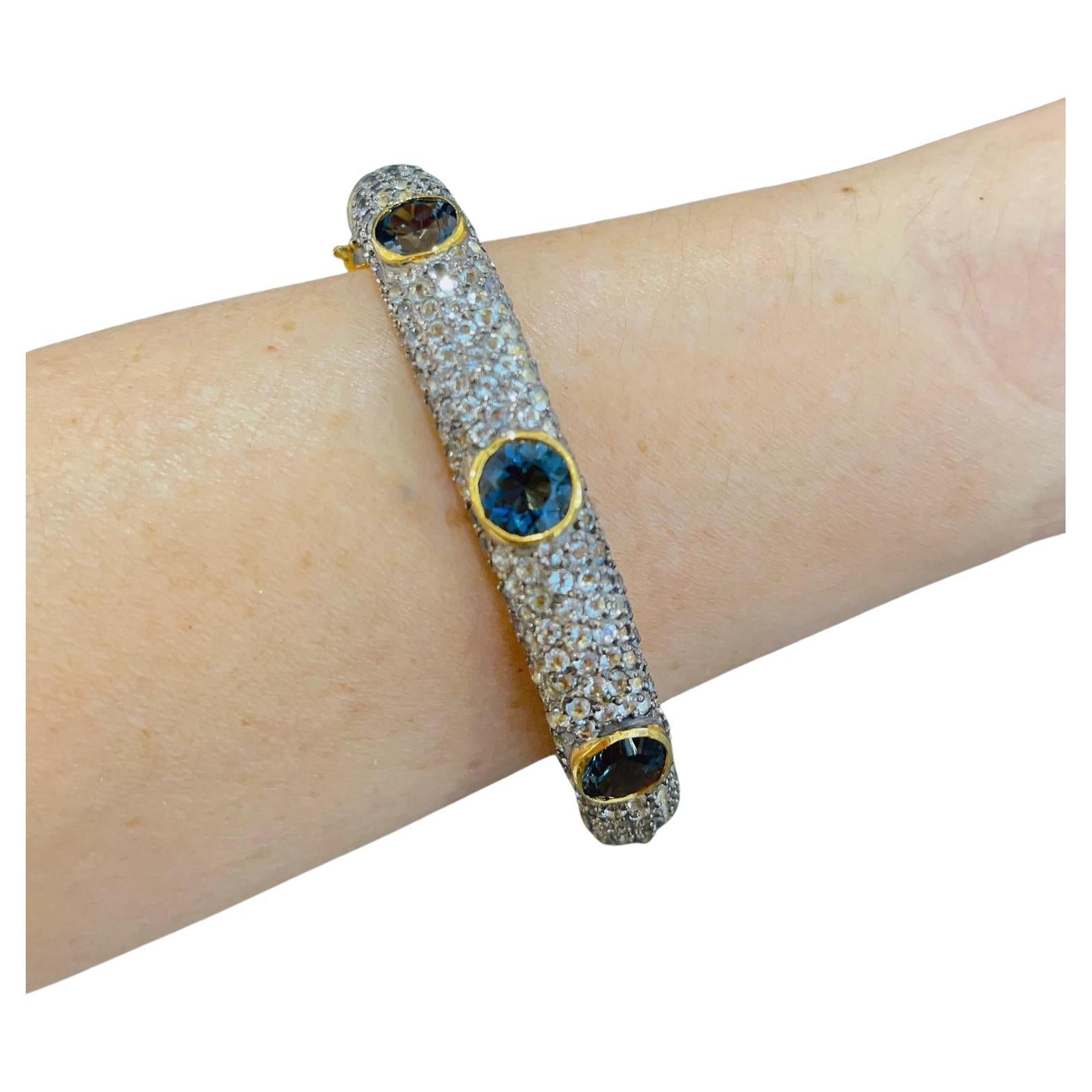 Bochic “Capri” London Topaz & White Zircon Bangle Set In 22K Gold & Silver 
Bochic Multi Gem “Capri” Bangle
The bangle had 2.2 Inch internal dimension and fits an average 7 inch wrist size
It has an open and close clasp and a safety hook
The inside