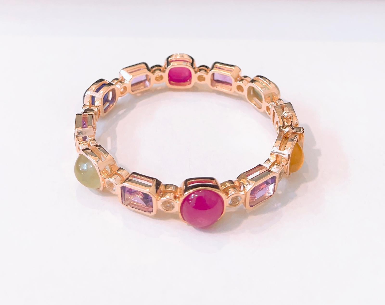 Bochic Multi Gem  “Capri” Bangle
Natural Green Amethyst Emerald cuts  - 8 Carats 
Natural Blue Sapphire Cabochon - 5 Carats 
Natural Red Ruby Cabochon - 9 Carats 
Set in 22K Gold and Silver 950
This bangle is perfect to wear day to night by Itself