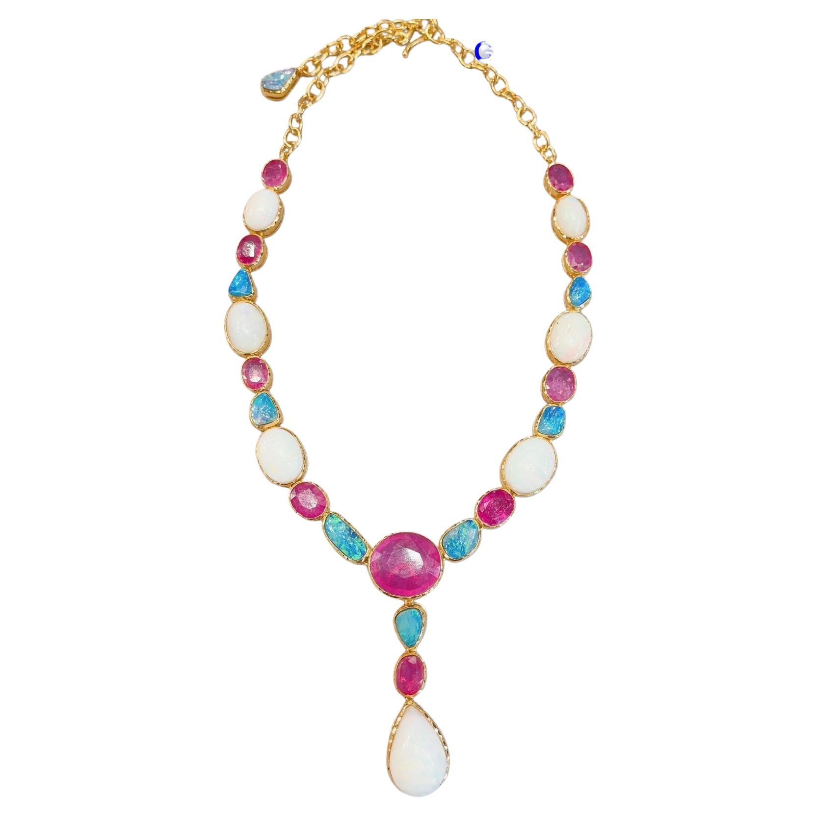 Bochic “Capri” Rich Multi Natural Gem Necklace & Earrings 
Necklace:
Natural Ruby, Colors - Red, Pink, 35 Carats 
Ethiopian White Opal and Australian Blue Opal, 34 Carats 
Set in 22K Gold and Silver 
Earrings:
Natural Ruby, Colors - Red, Pink, 7