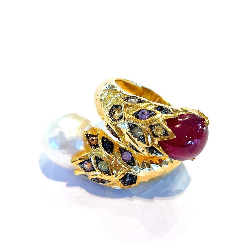 Bochic “Capri” Natural Red Ruby & Rose Sapphire Ring Set in 18K Gold & Silver 

Natural Ruby Cabochon - 12 Carats 
Natural Multi color Sapphires from Sri Lanka , round brilliant shapes - 4 carats 
White South sea pearl 

This Ring is from the