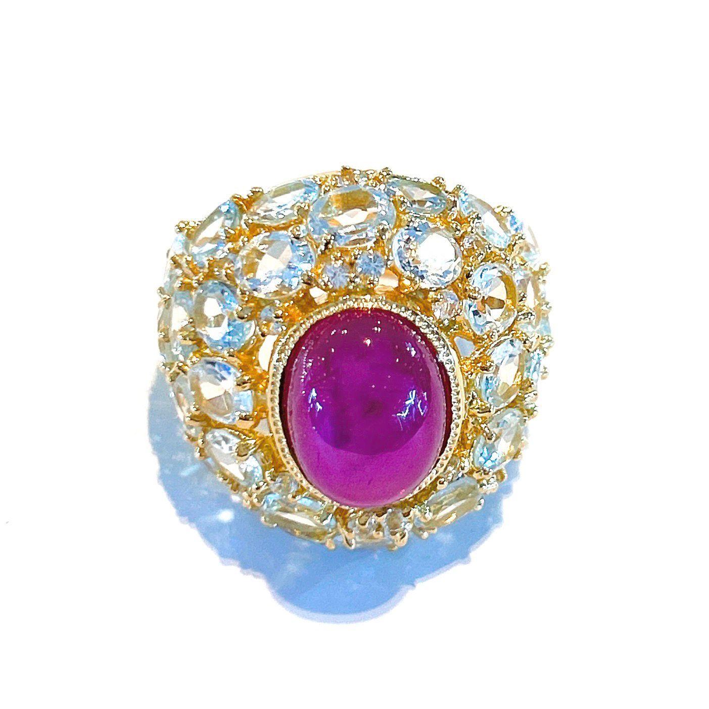 Bochic “Capri” Cocktail Ring 
Natural Beautiful Deep Red Ruby Cabochon - 9 carats
Natural Oval brilliant shape Blue Topaz - 22 carats 
Set in 22K Gold and Silver 950
This Ring is perfect to wear - Day to night, swim wear to evening wear.
Vintage
