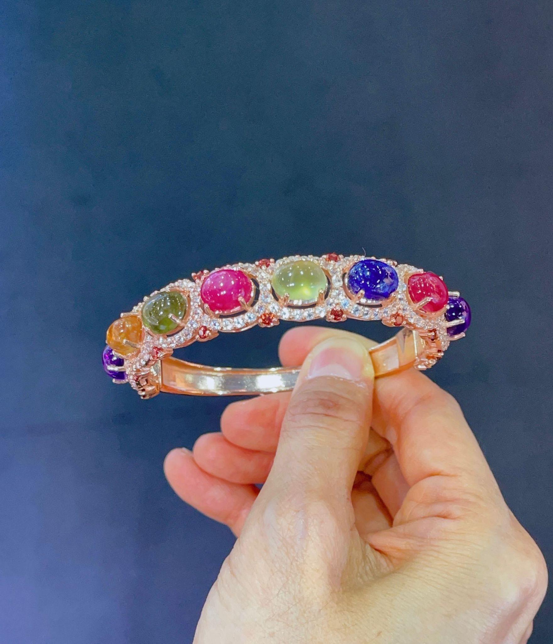 Bochic “Capri” Red Ruby & Multi Color Sapphires Bangle Set In 18K Gold & Silver 
Natural Blue Sapphire 
Natural Yellow Sapphire 
Natural Green Sapphire 
All large cabochon shapes 
40.24 Carats 
Natural Red Ruby 
Natural Penite 
All Cabochon shapes