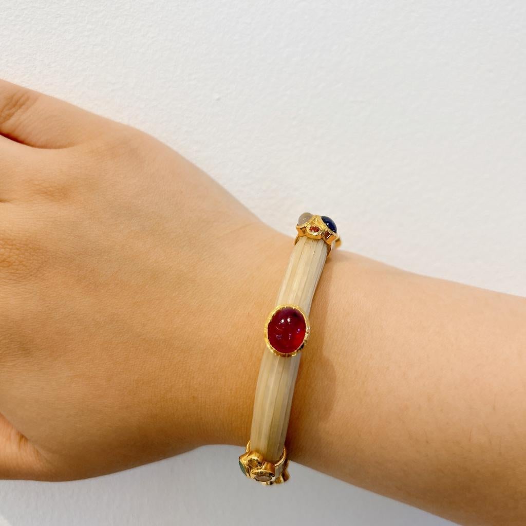 Bochic “Capri” Ruby, Emerald & Moonstone Bangle Set In 18K Gold & Silver 
Natural Red Ruby Cabochon - 4 carat 
Natural Sapphire Cabochon - 2 Carat 
Natural Emerald Cabochon - 2 Carat 
Natural Moonstone Cabochon - 2 Carat 
Bangle is made from