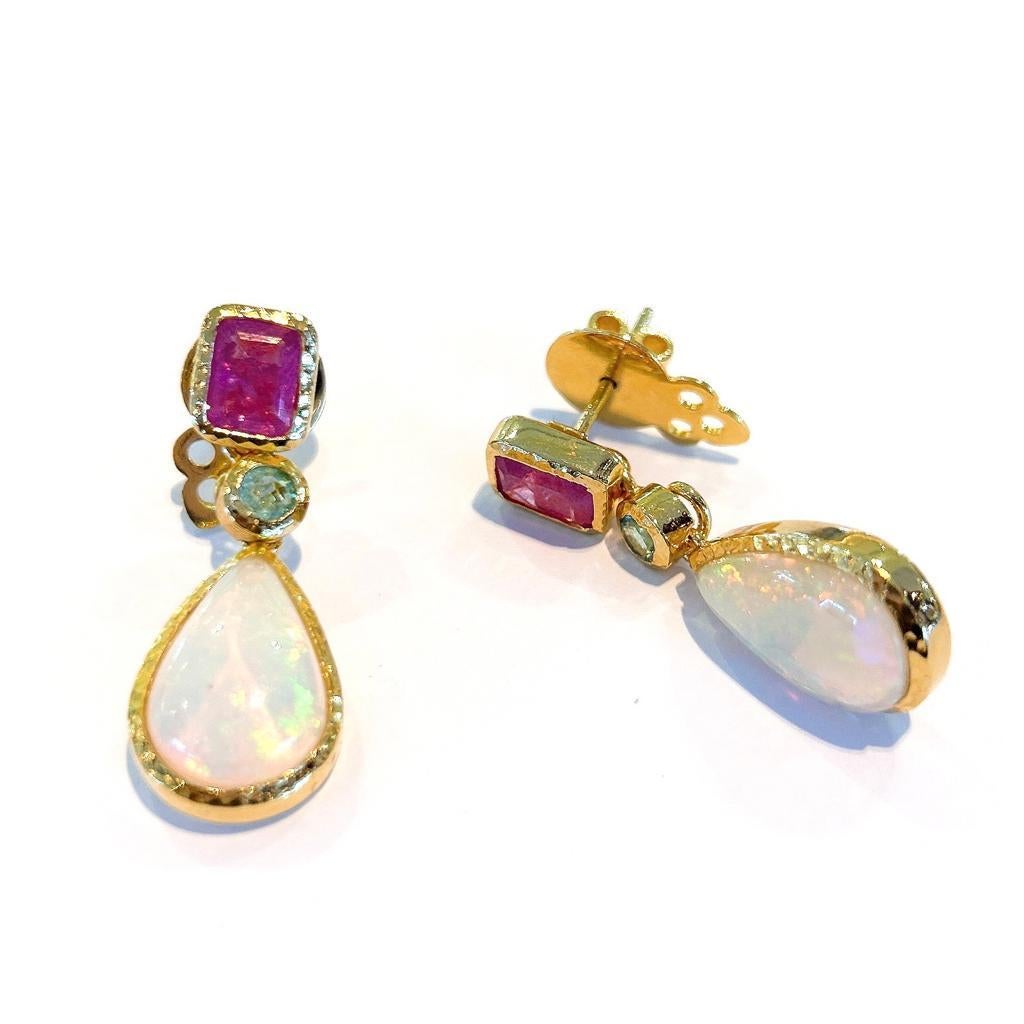 Bochic “Capri” Ruby, Emerald & White Opal Earrings Set In 18K Gold & Silver 
Redish Pink Natural Rubies - 4 carats 
Square shapes 
Green Natural Emeralds from Zambia - 1 carat
Round brilliant shapes 
White opals - 10 carat 
Pear shapes 
The earrings