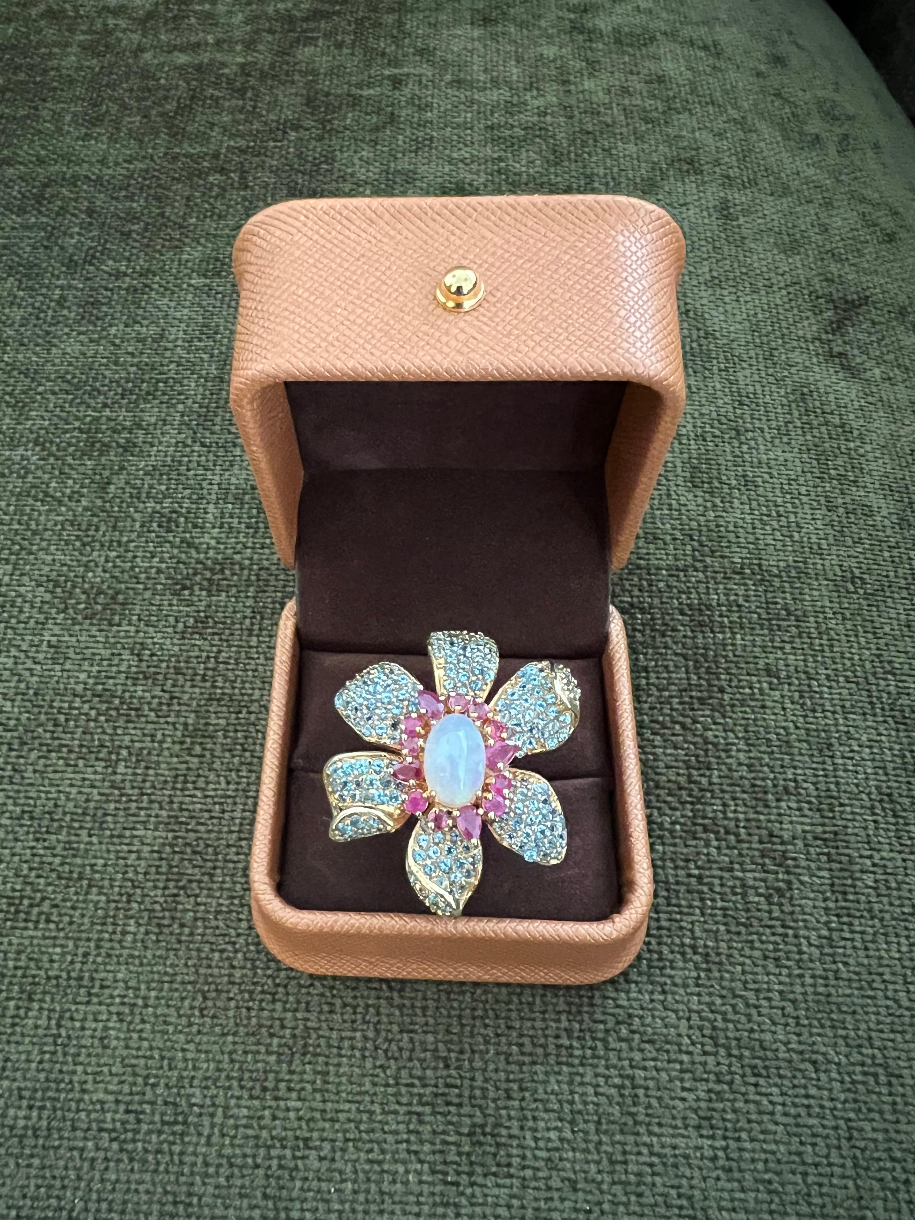 Bochic “Capri” Ruby, Fire Opal & Blue Topaz Flower Ring Set 18K Gold & Silver 

Natural Cut Ruby  - 2.00 carats 
Natural Fire Opal - 3.00 carats 
Natural Blue Topaz 2.00 carats 
Natural White Topaz - 1.00 carats 

This Ring is from the 