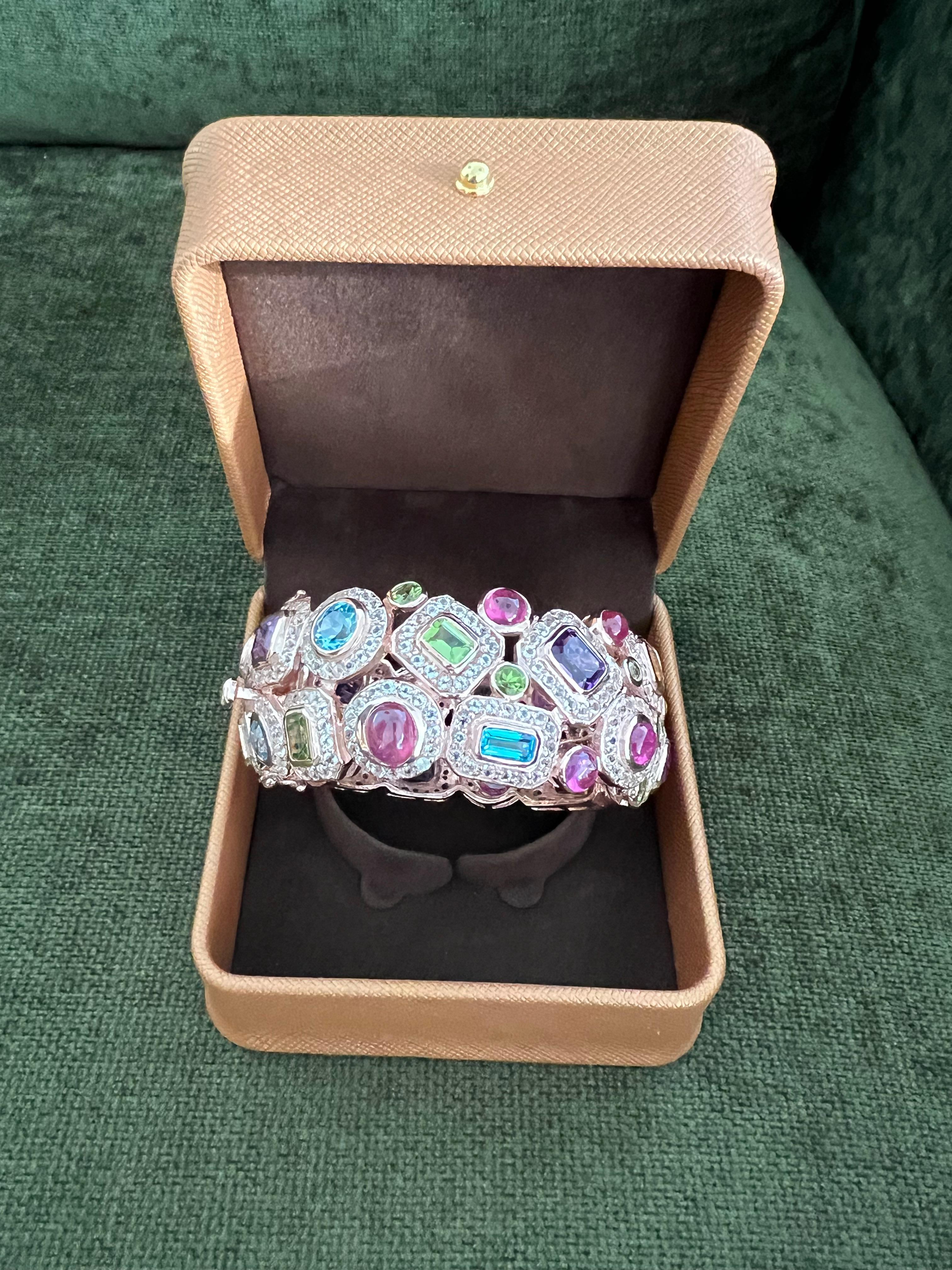 Bochic “Capri” Ruby & Multi Color Gem & Sapphire Bangle Set In 18K Gold & Silver

Natural Blue Topaz - 5 Carats 
Natural Red Ruby  - 6 Carats 
Natural White Topaz - 3 Carats 
Natural Peridot  - 3 Carats 
Natural Amethyst - 5 Carats 

The Bochic