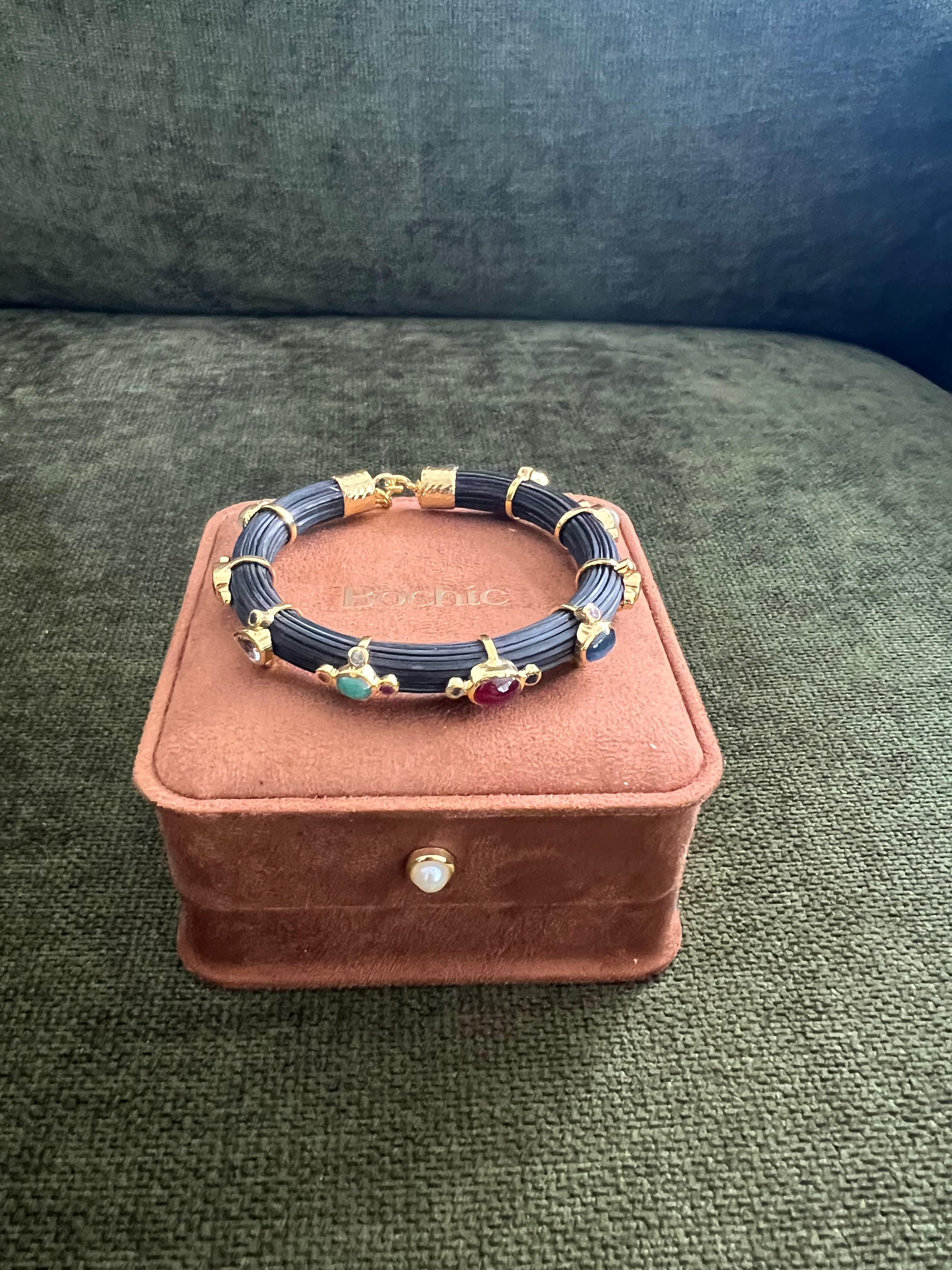 Bochic “Capri” Ruby & Multi Color Sapphire Bangle Set In 18K Gold & Silver
open and close hinge and safety locks 

Natural Red Ruby  - 3 Carats 
Natural Blue Sapphire - 4 Carats 
Natural Multi Gem - 5 Carats 

The Bochic 