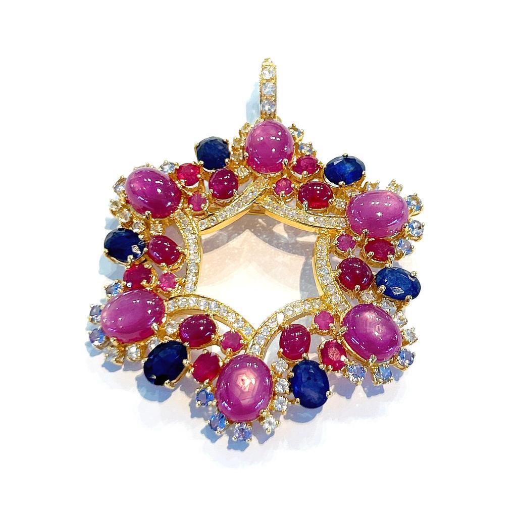 Bochic “Capri” Ruby & Sapphire Brooch/Pendent Set In 18K Gold &Silver 
Natural Red Ruby, Cabochon shapes - 63 Carats 
Natural Blue Sapphires, Oval brilliant shapes - 12 Carats
White Topaz - 4 Carat  
Tanzanite - 1 carat 

This Brooch/Pendent is from