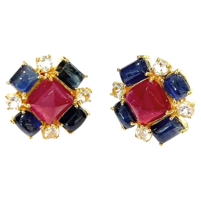 Bochic “Capri” Ruby & Sapphire Clip On Earrings Set In 18K Gold & Silver 

Natural Red Ruby Square Cabochons - 14 Carats 
Natural Blue Sapphires Square Cabochons -12 Carats 
Natural White Topaz - 8 Carats 

The earrings from the 