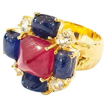 Bochic “Capri” Ruby & Sapphire Cocktail Ring Set In 18K Gold & Silver 

Red Natural Ruby Square Cabochon - 7 Carat 
Blue Natural Sapphire Cabochon - 10 Carat 
White Natural Topaz - 2 Carat 

This Ring is from the 