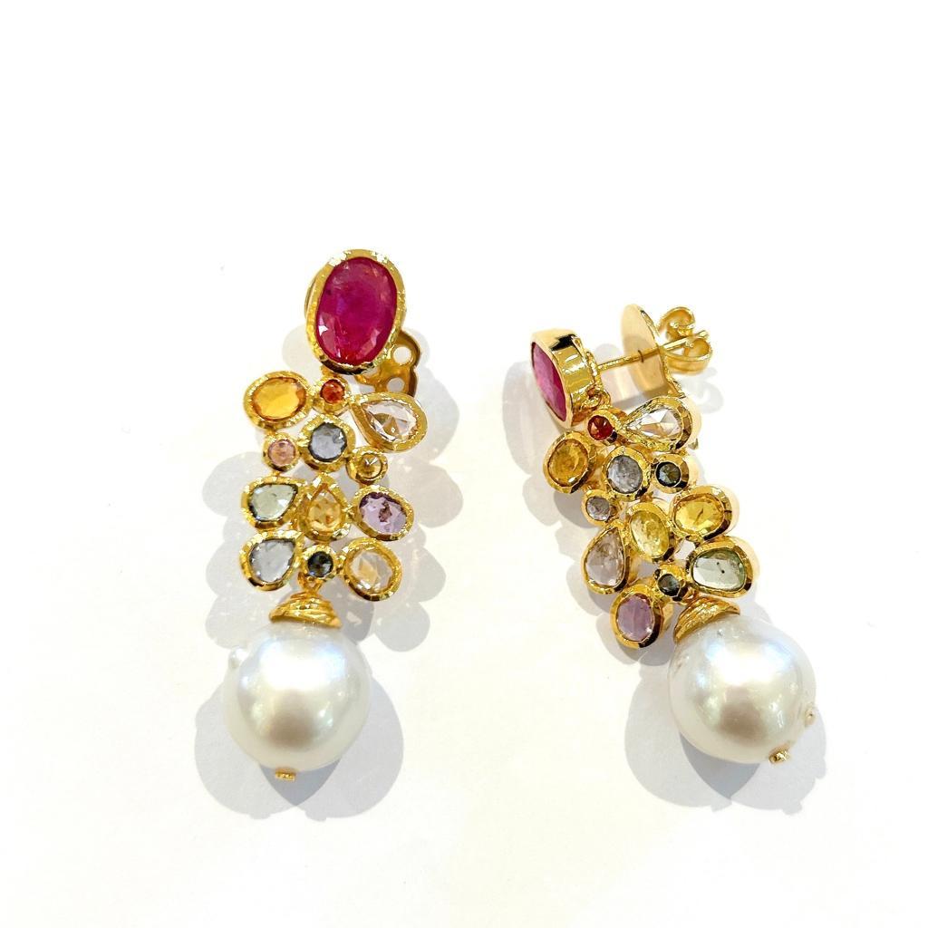 Bochic “Capri” Sapphire & South Sea Pear Earrings Set In 18K Gold & Silver 
Red Ruby , Oval shape - 8 Carat
Rose Cut Multi color Sapphire from Sri Lanka - 6 Carat
South Sea Pearls, White color and Pink tone 

The earrings from the 