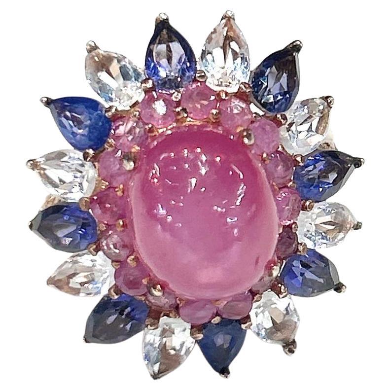 Bochic “Capri” Ruby, Tanzanite & White Topaz Cocktail Ring In 18K Gold & Silver 

Natural Ruby Cabochon  - 7.00 carats 
Natural Tanzanite - 5.00 carats 
Natural Round Brilliant Rubies - 1.50 carats 
Natural White Topaz - 5.00 carats 

This Ring is