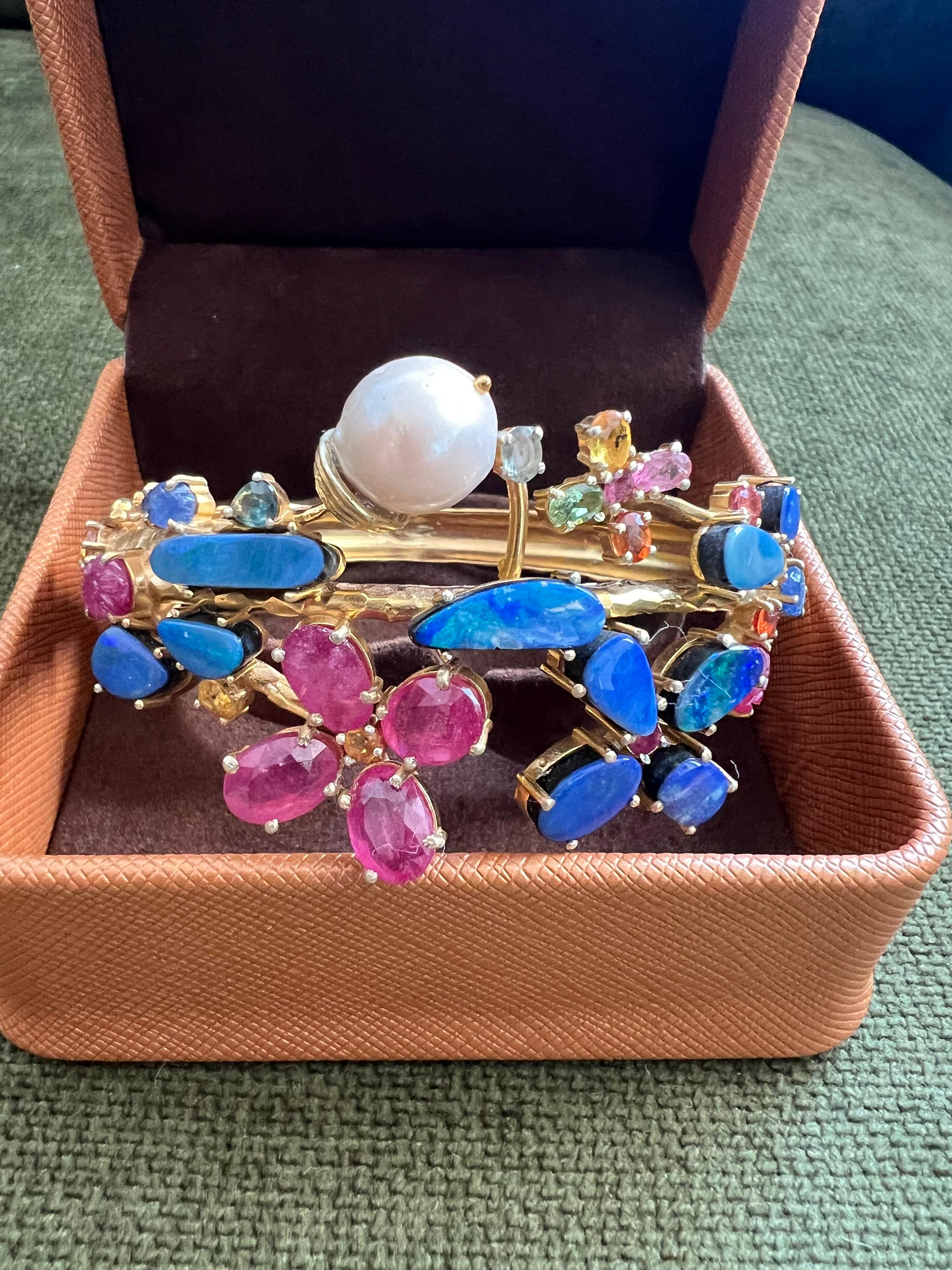 Bochic “Capri” Ruby, Sapphire  & Blue Opal Cuff Set In 18K & Silver 

Red Ruby 
Blue Opal
Multi Color Sapphires
12 Carats 

(Note that the Model Images are for Color tones, Style and Size )

The Bochic 