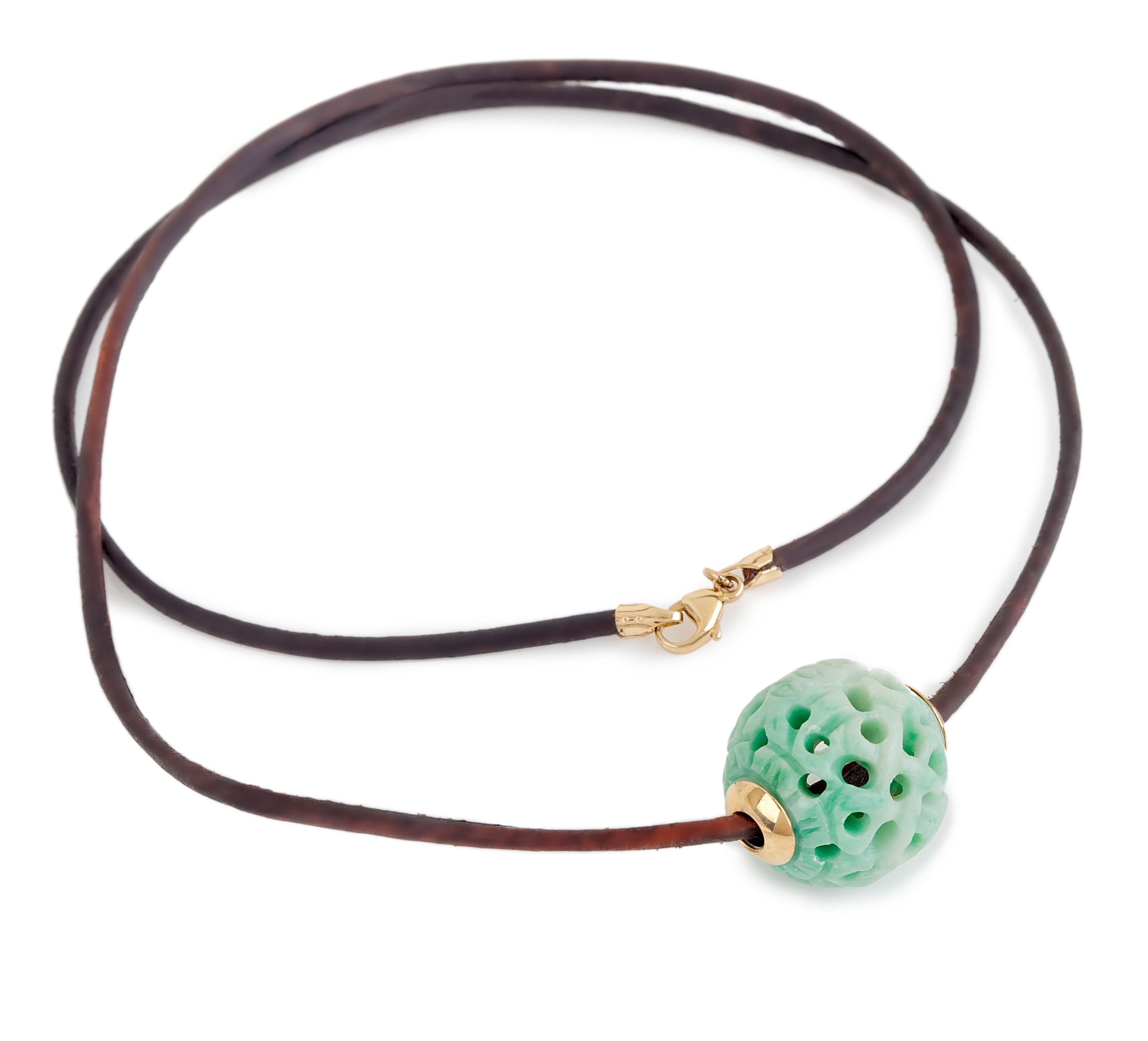 Bochic Vintage Carved Jade Ball Necklace 
Chocker length 
18 K gold 
The Jade Carved bead is antique, taken out from an old necklace 50 - 100 years. 
Origin China 
The necklace is made of lather 
Signed 
Comes with a Bochic pouch. 
Bead is green