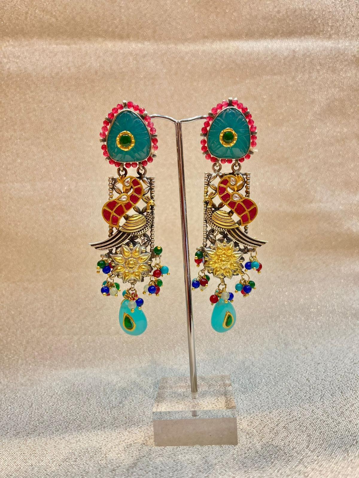 Bochic “IndoChina” Oriental Vintage Silver & Enamel Blue, Red Bird Earrings 
Turquoise
Rose cut Diamonds 
Rubies
Emeralds 
Sapphires 

The earrings from the 
