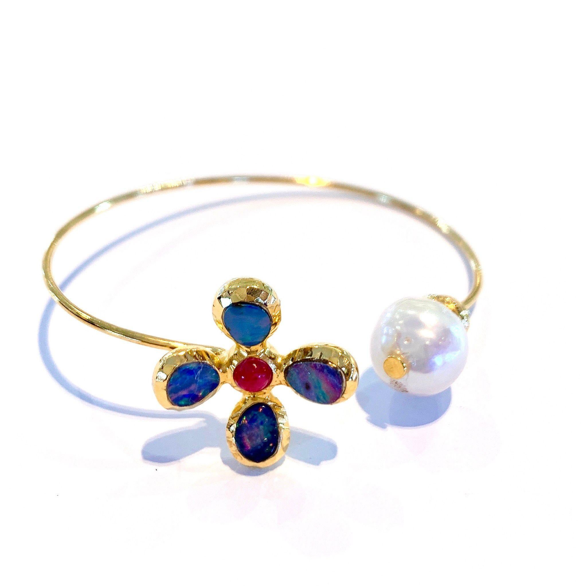 Bochic Opal and South sea Pearl Bangle, Silver and 22 K Gold 
Gold is 22K plating that is 3 microns 
Natural Blue Opal 
Natural shape 
3 carats 
Baroque south sea pearl 
White color, silver and pink tone 
Natural Red Ruby 
Cabochon
1 .5 carat